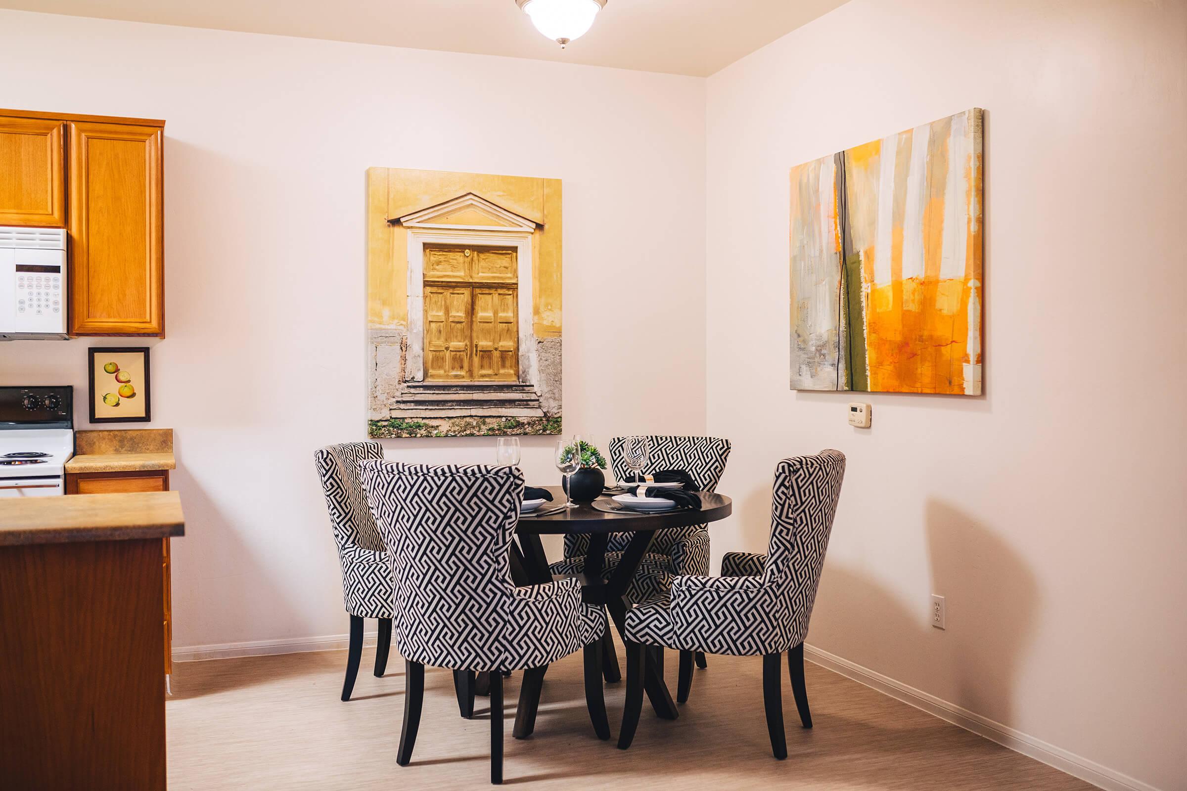 furnished dining room with paintings