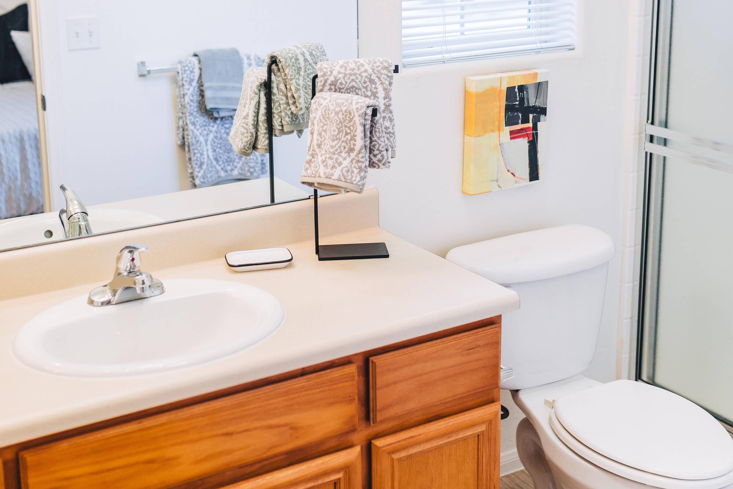furnished bathroom with tan countertops