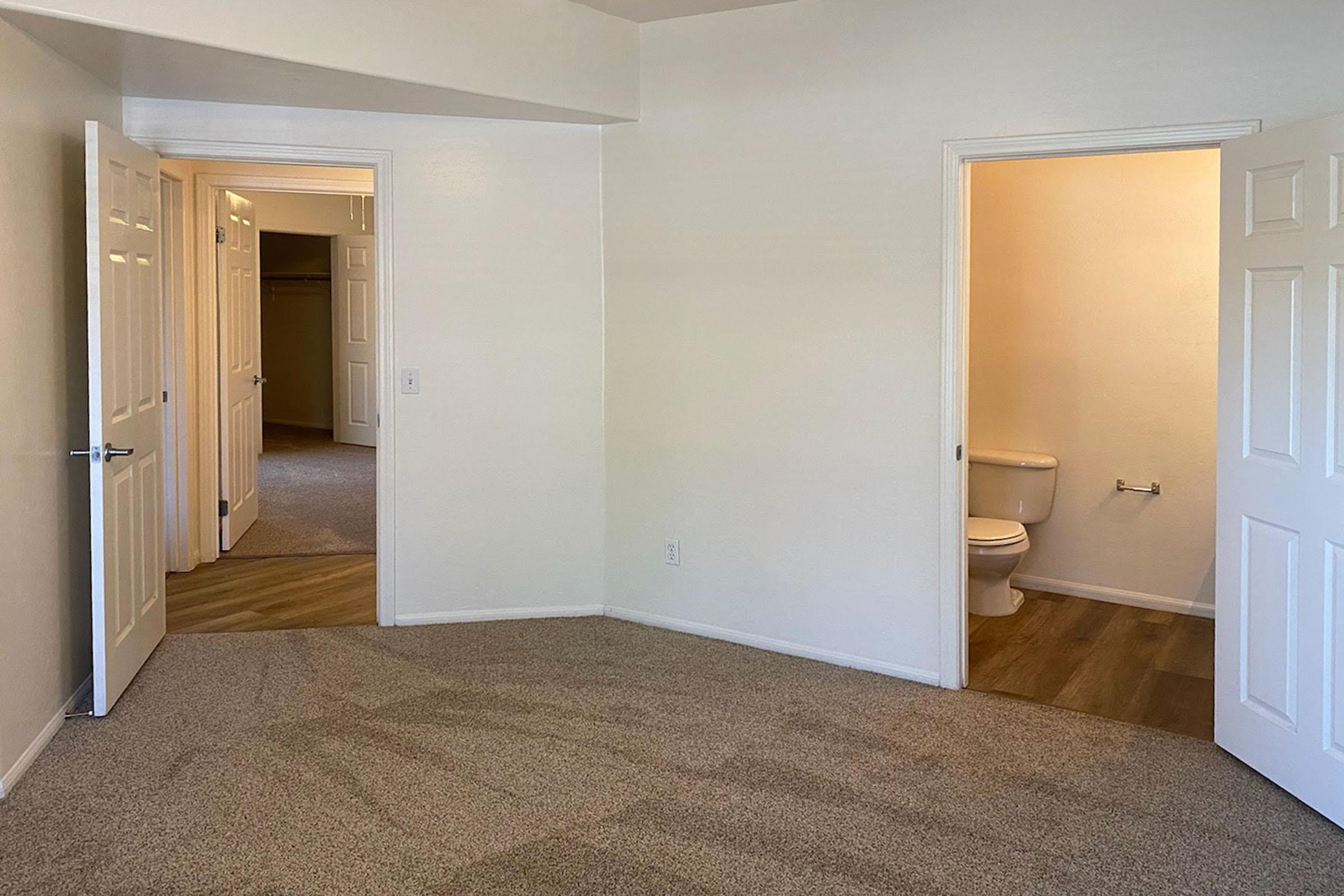 unfurnished carpeted bedroom with attached bathroom