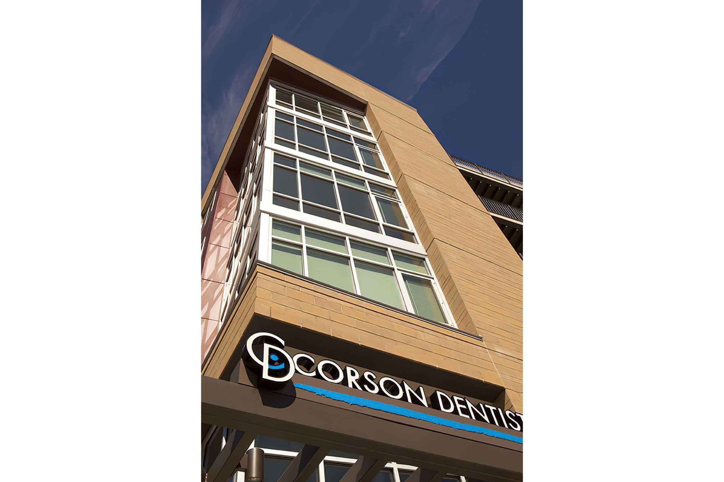 A modern building with a prominent sign that reads "Corson Dentist."