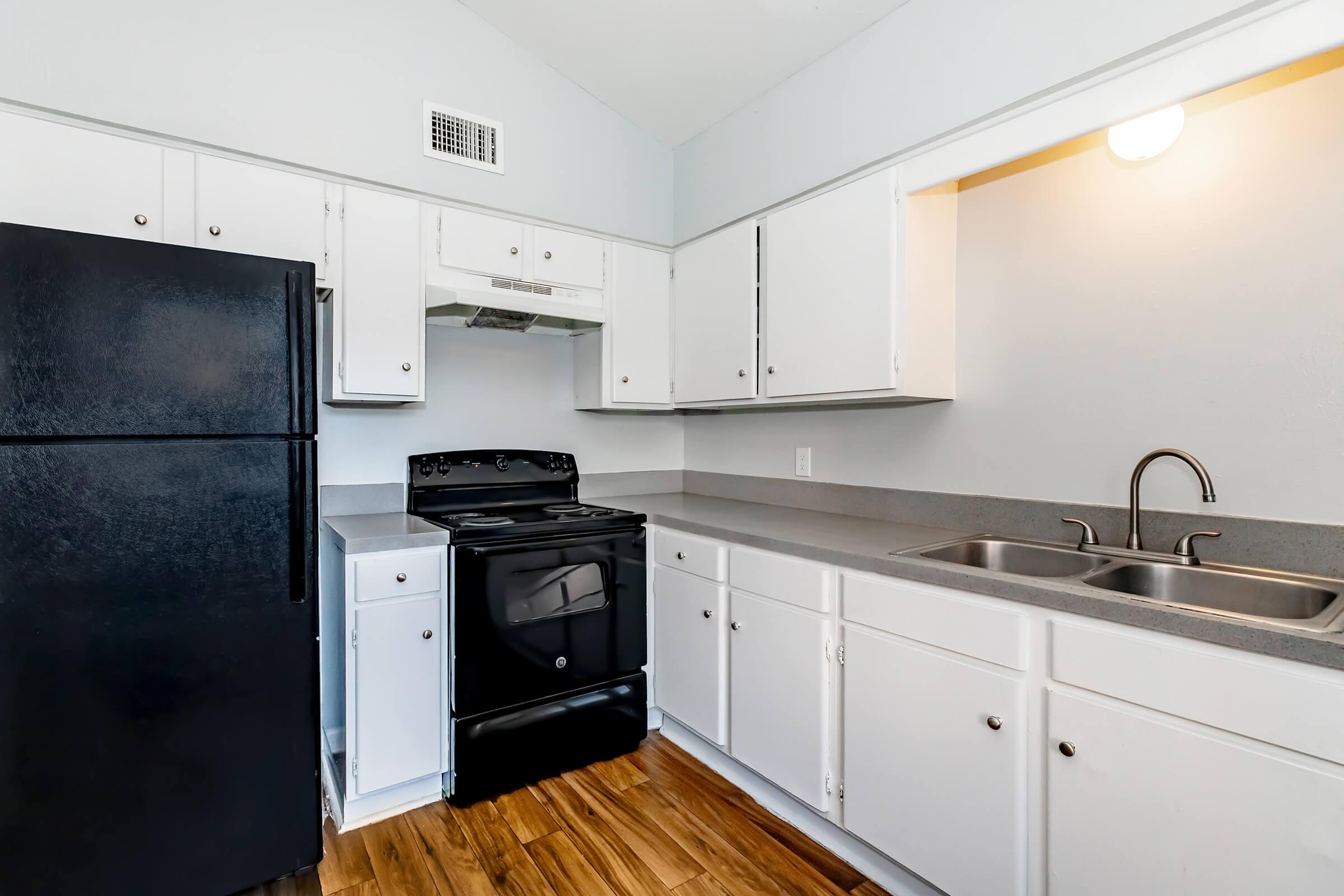 a kitchen with a stove and a refrigerator