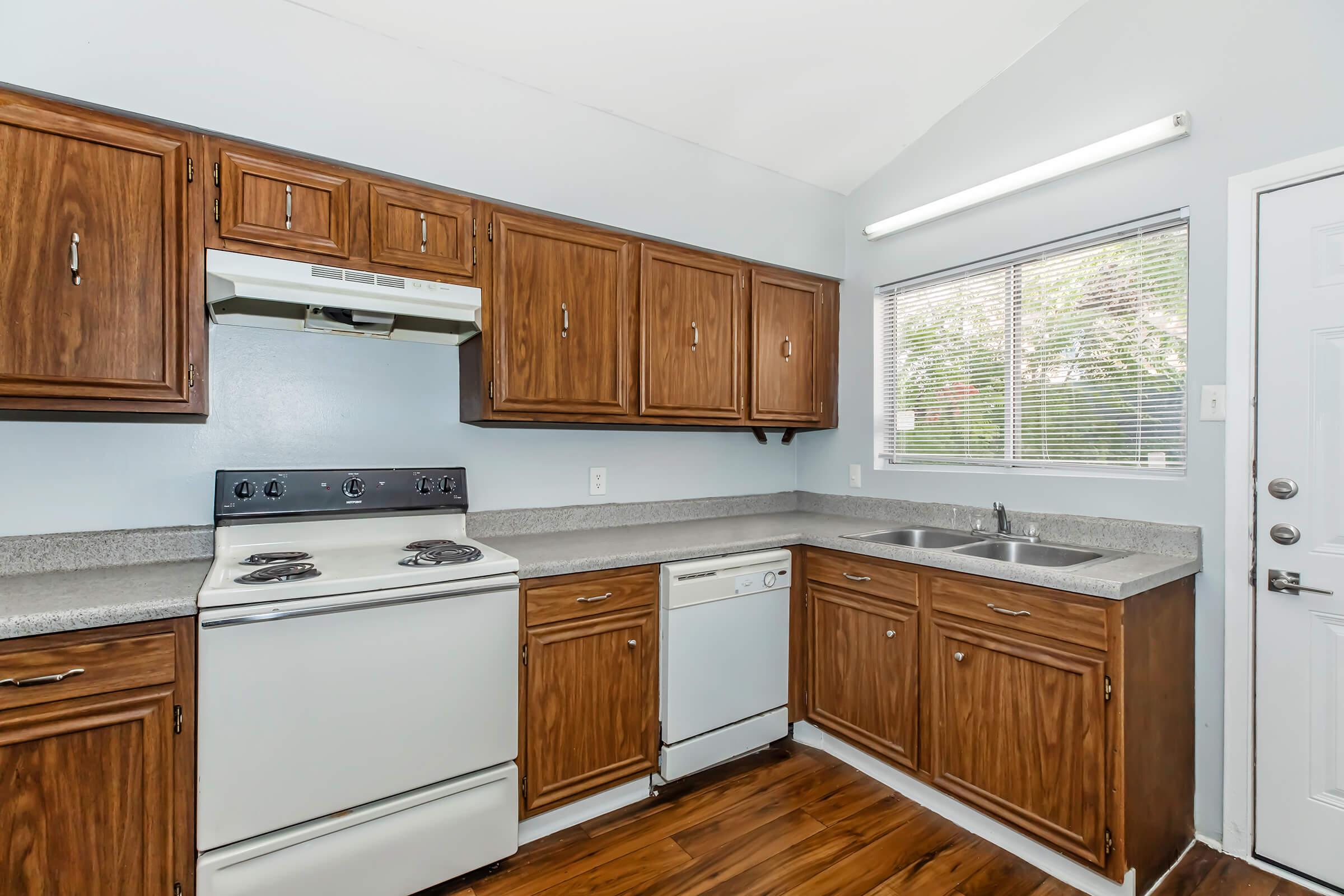 a kitchen with wooden cabinets and a microwave