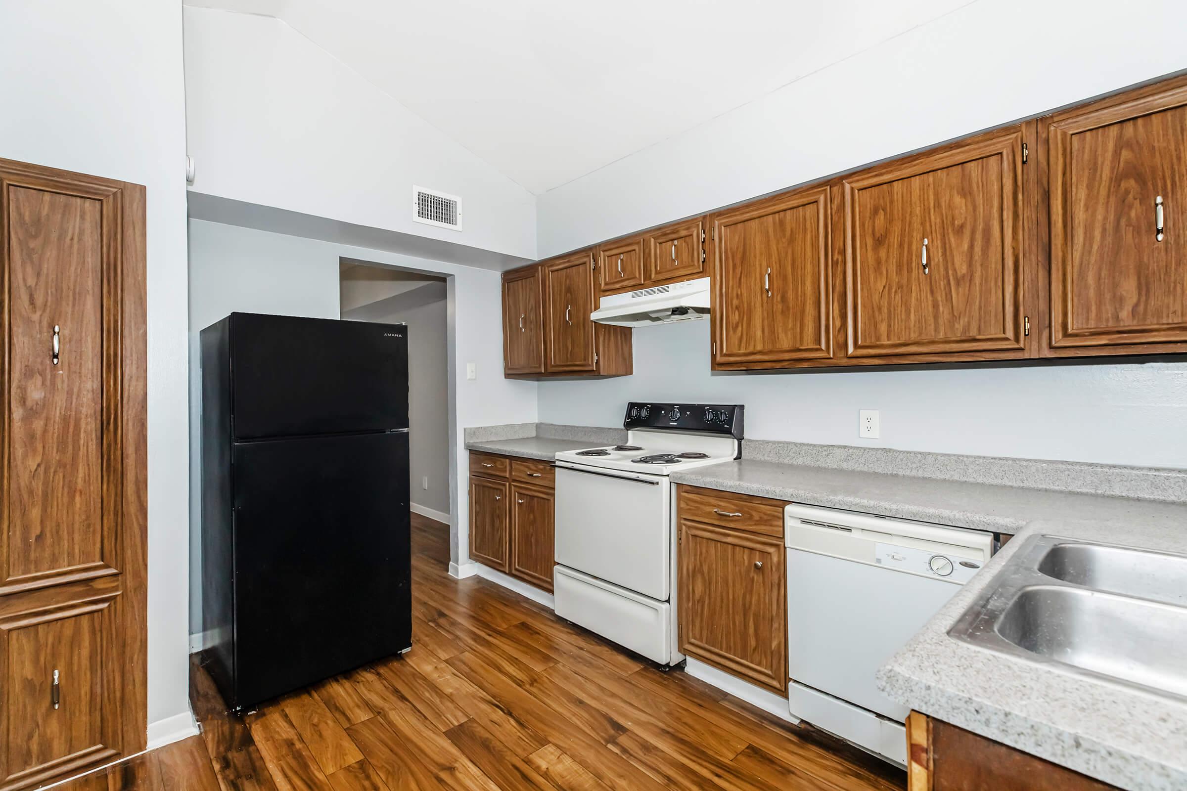 a kitchen with stainless steel appliances and wooden cabinets