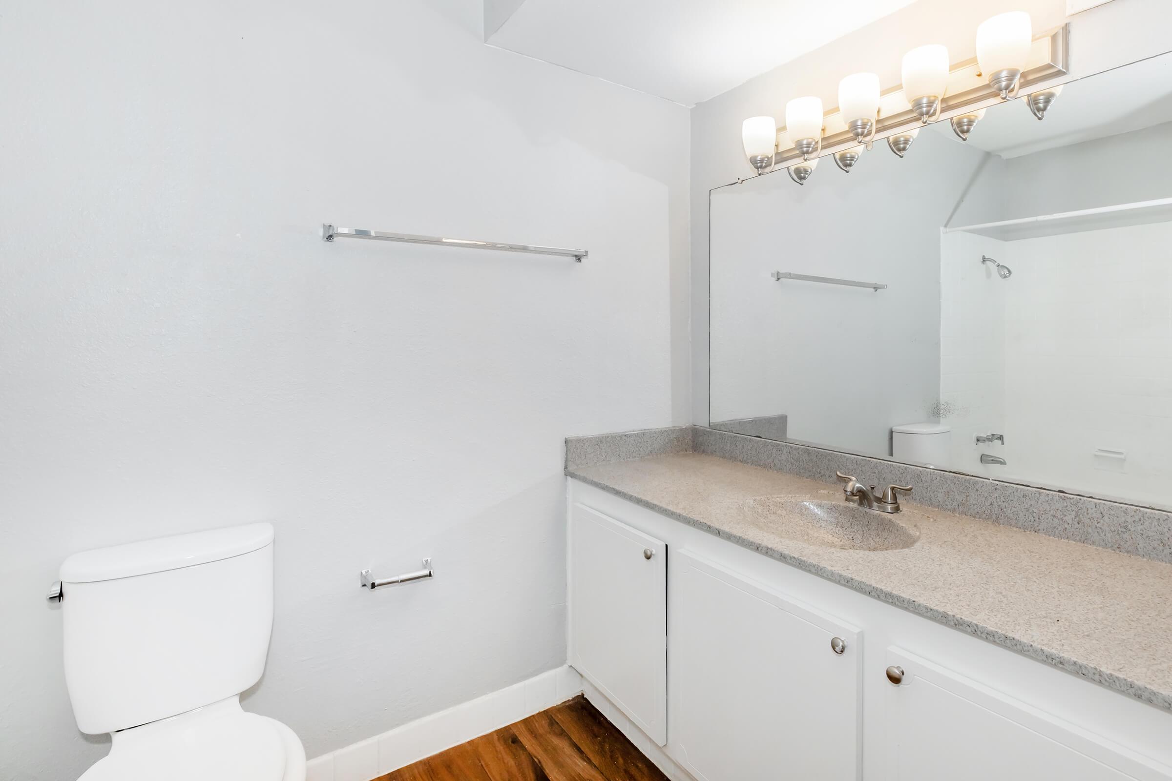 a kitchen with a sink and a mirror