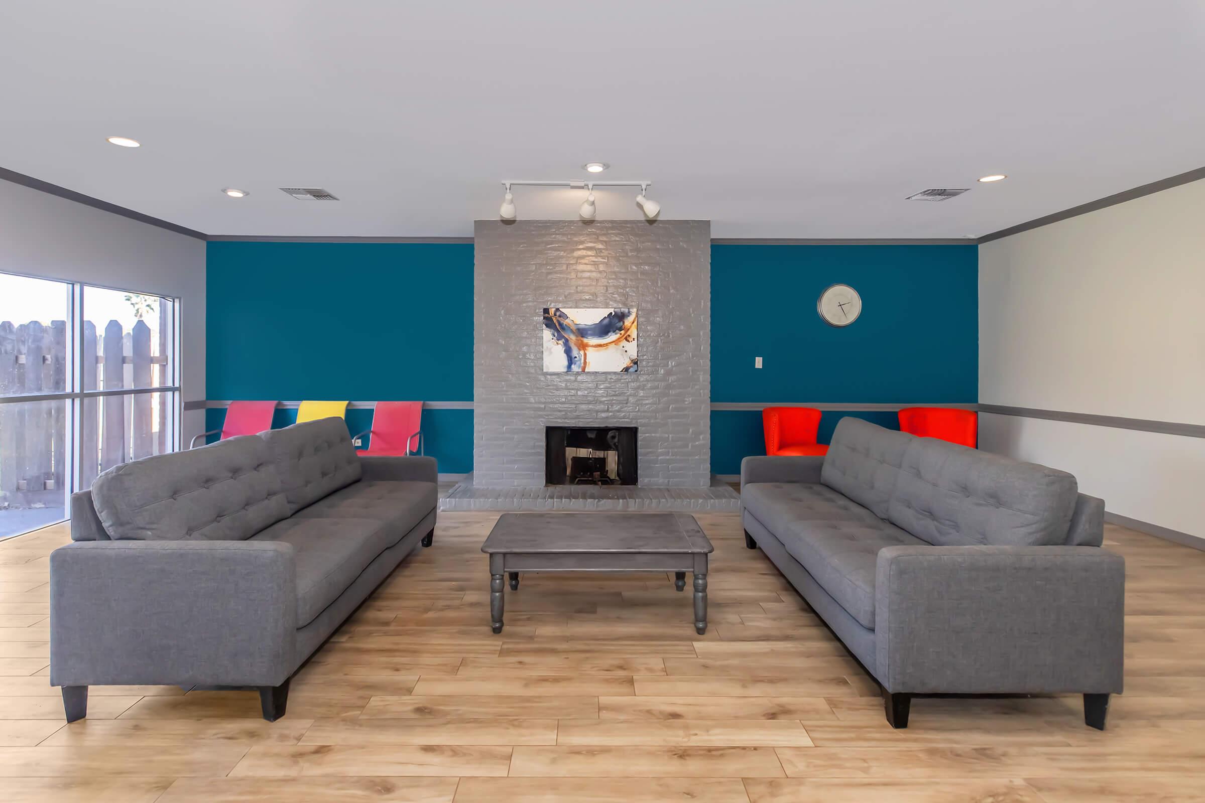 a living room filled with furniture and a fireplace