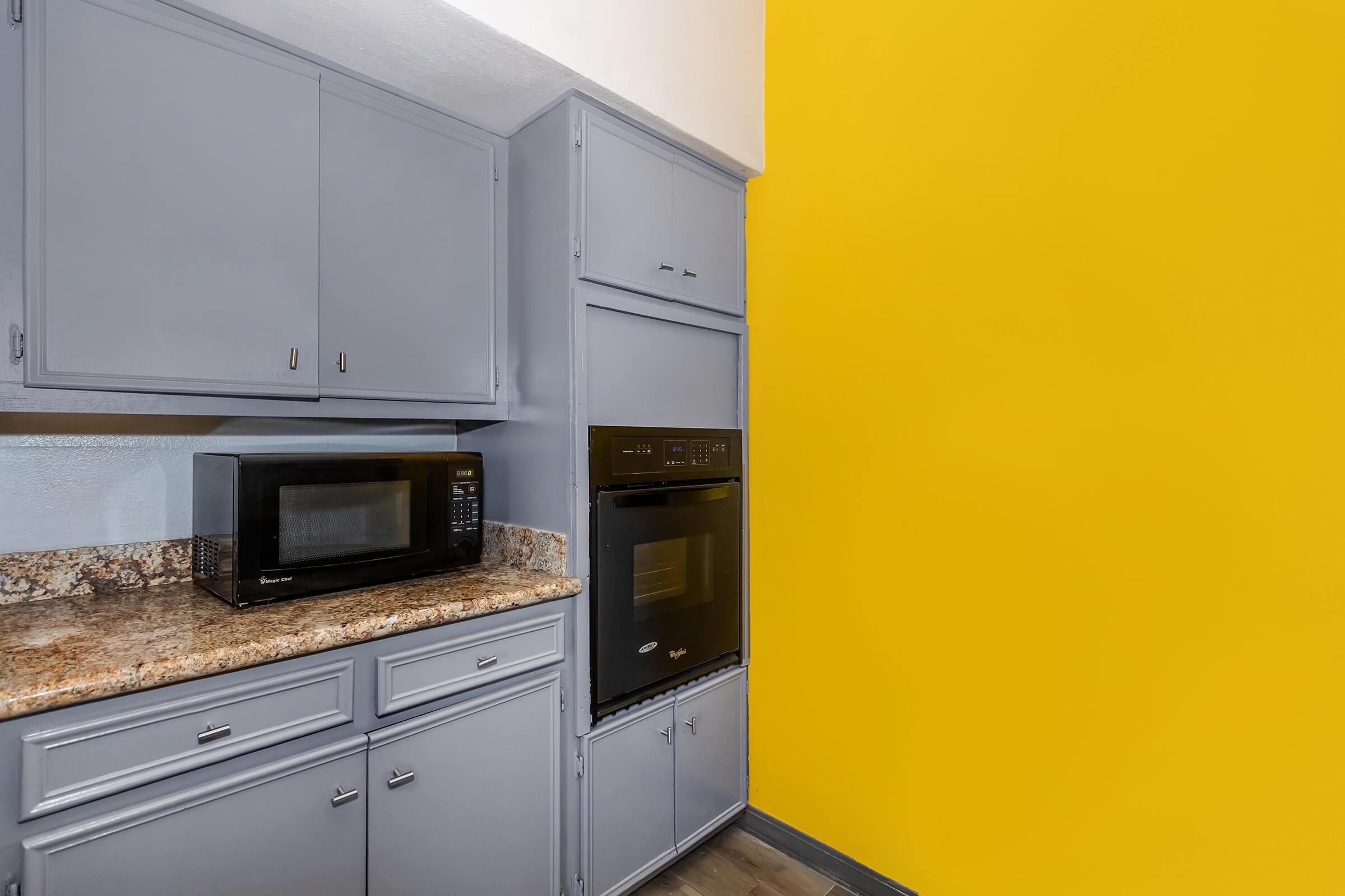 a stove top oven sitting inside of a kitchen