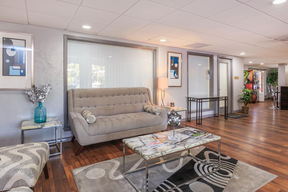 a living room filled with furniture and a large window