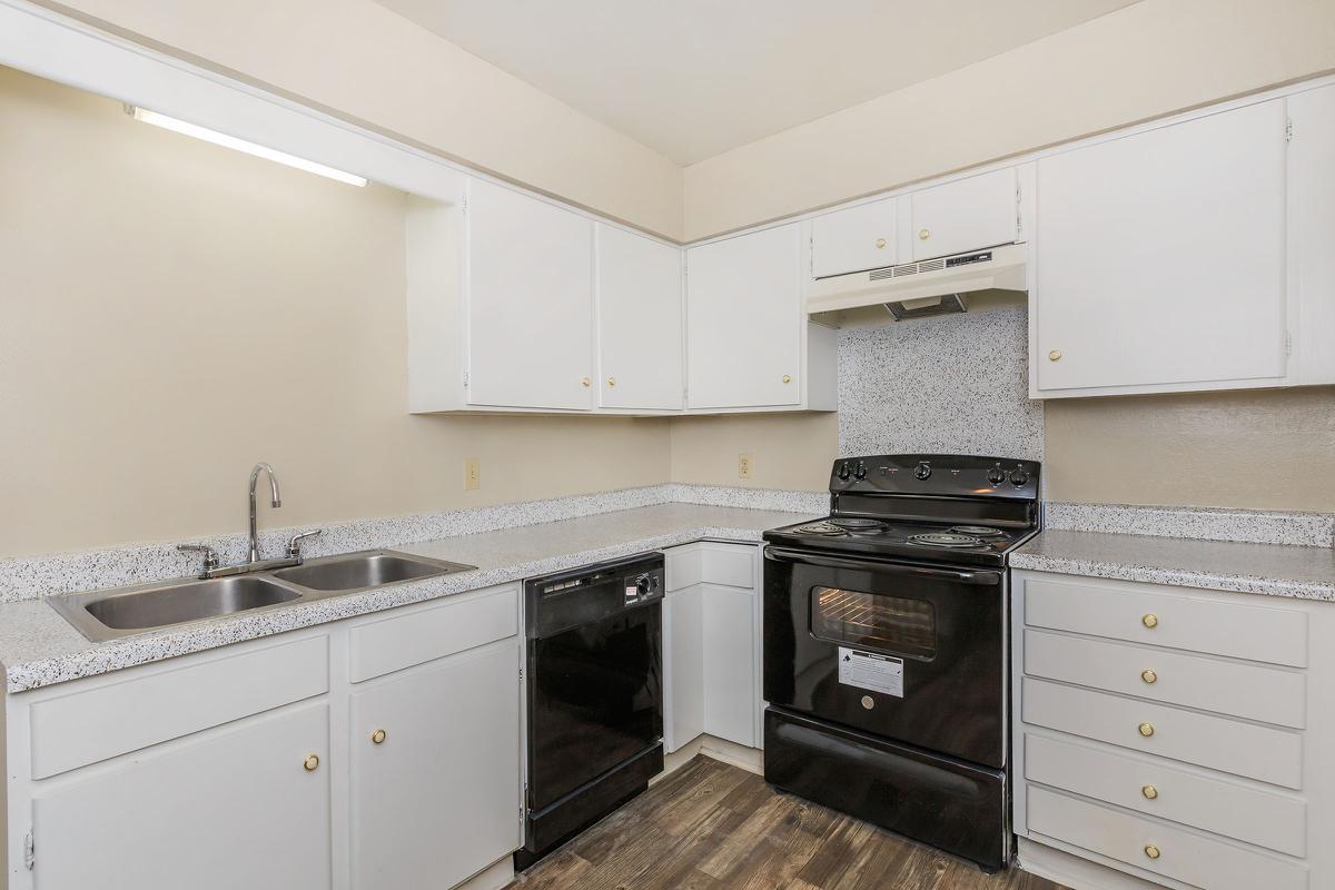 a kitchen with a stove and a refrigerator