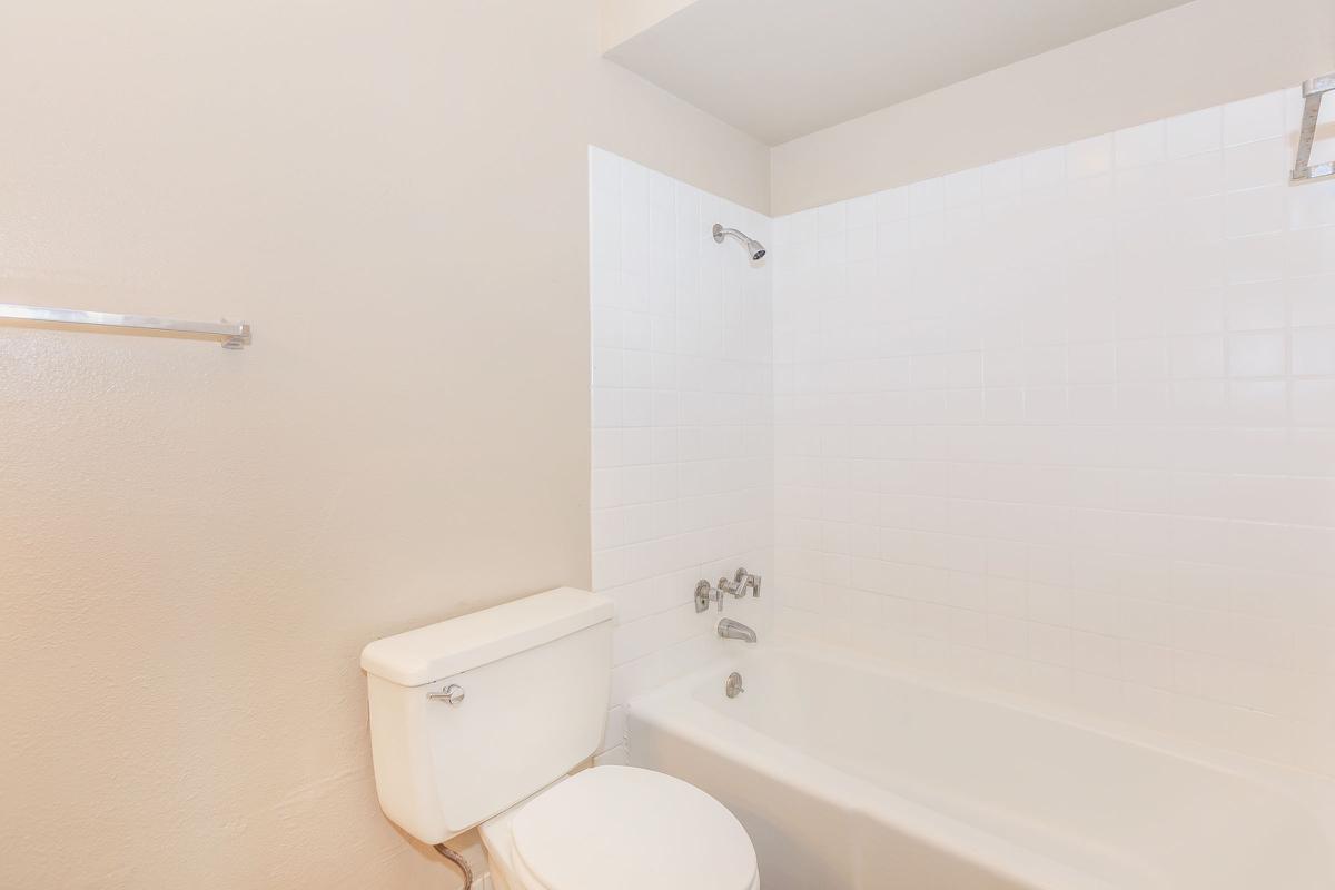 a white sink sitting under a mirror