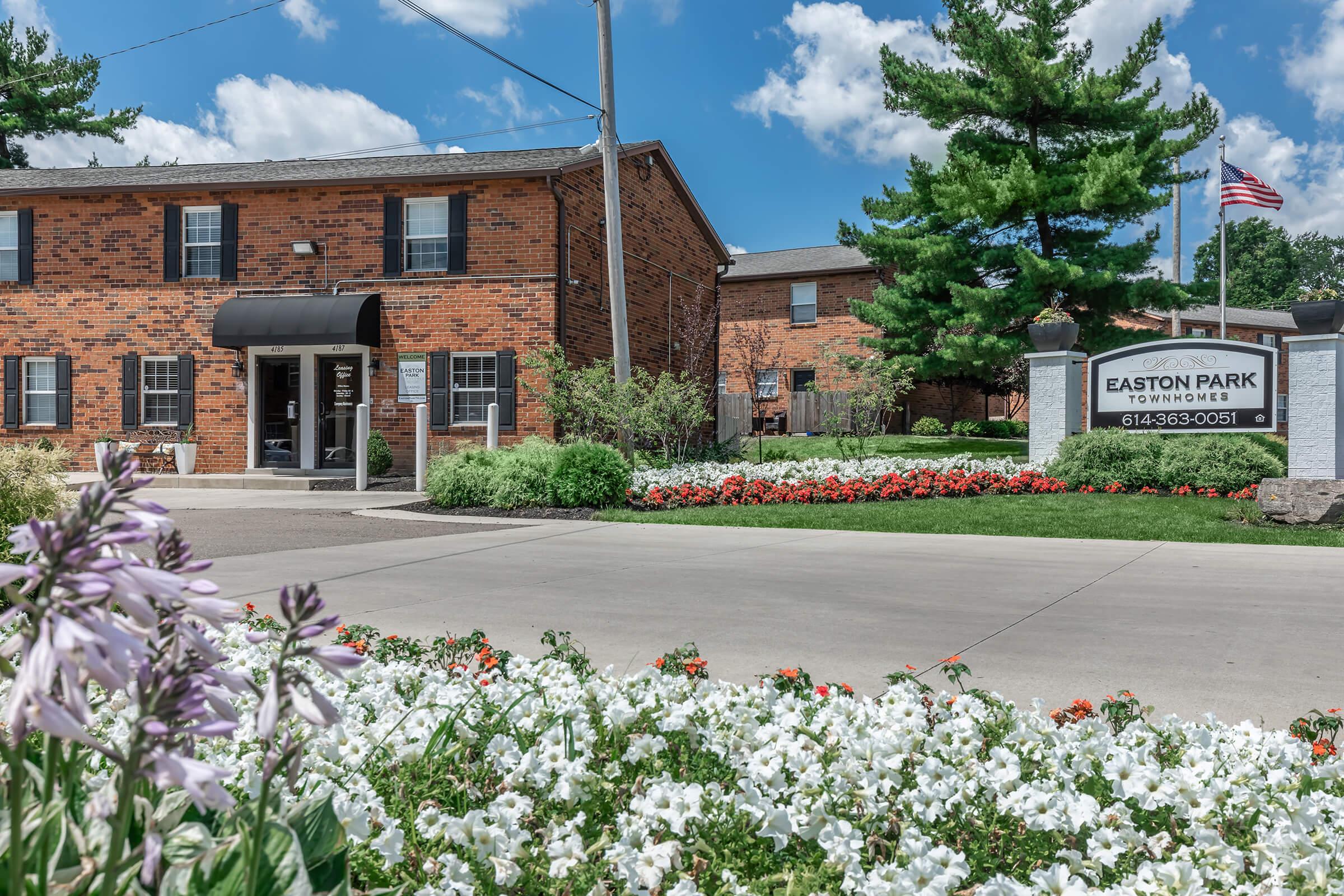 a close up of a flower garden in front of a building