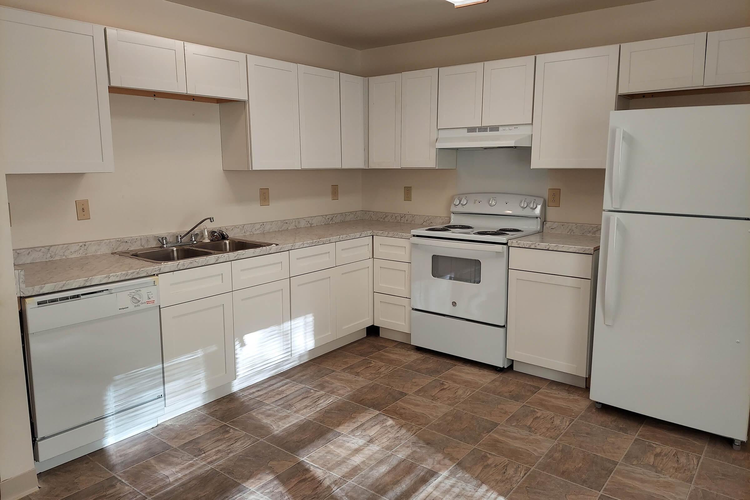 a kitchen with a stove and a refrigerator