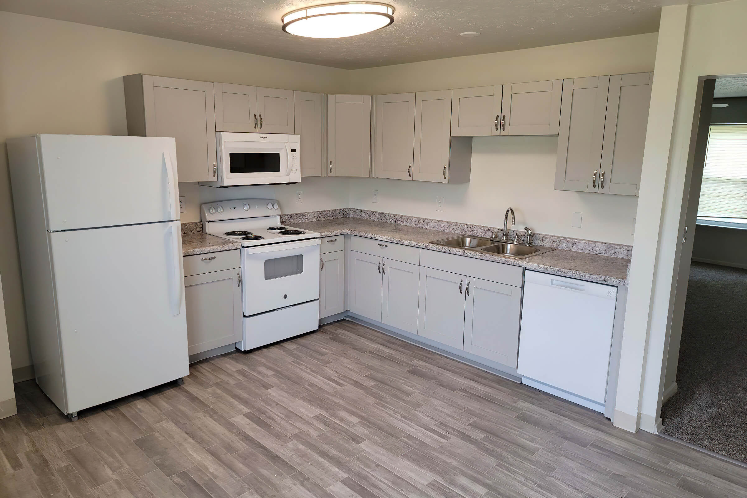 a kitchen with a stove and a refrigerator