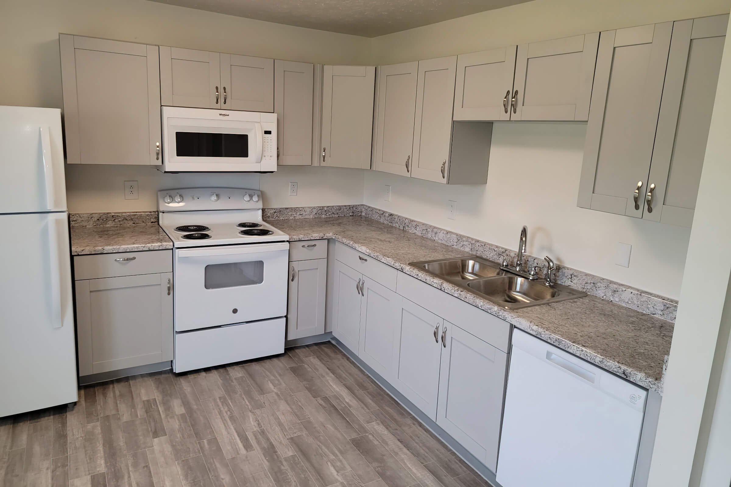 a stove top oven sitting inside of a kitchen