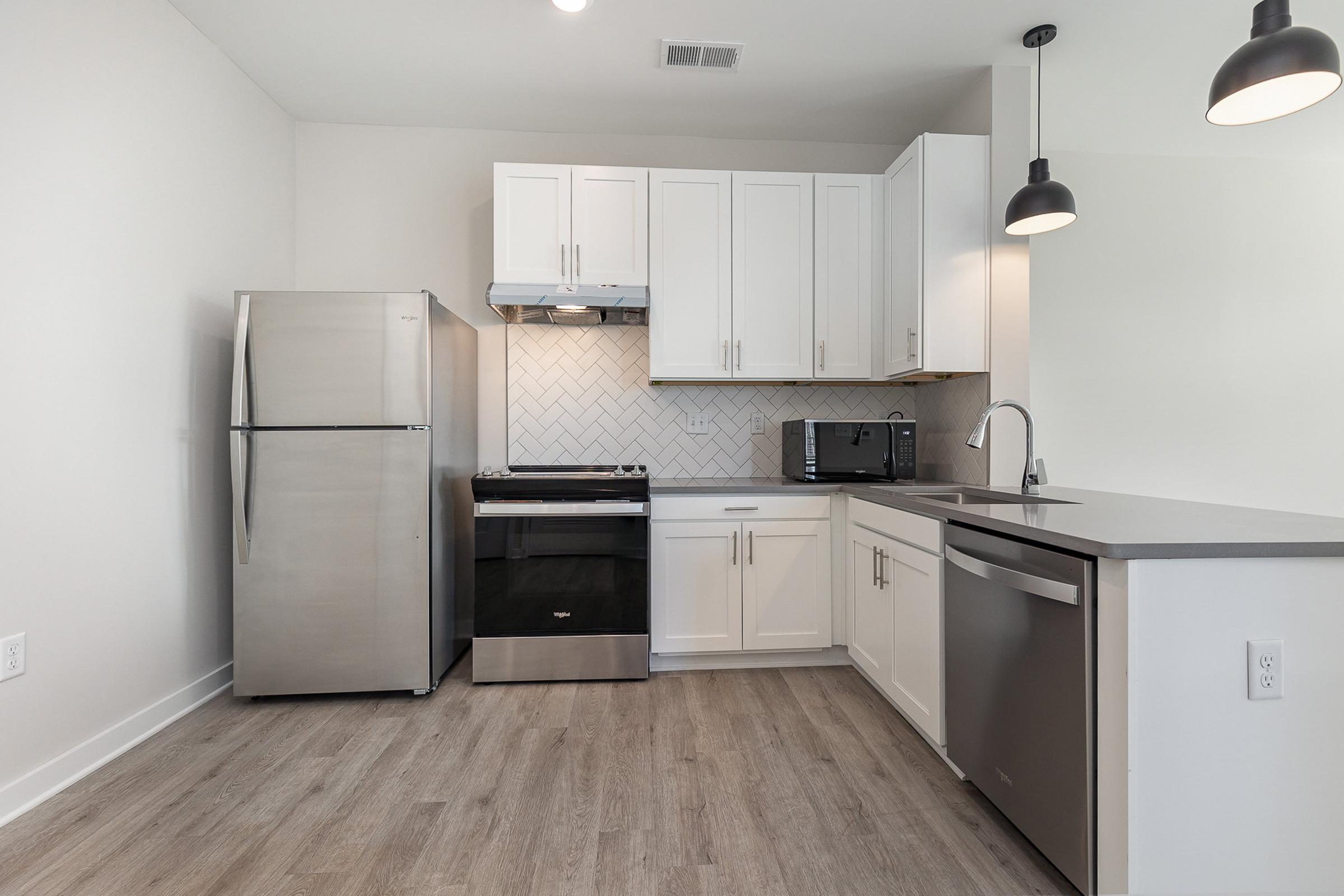 a kitchen with a stove and a refrigerator