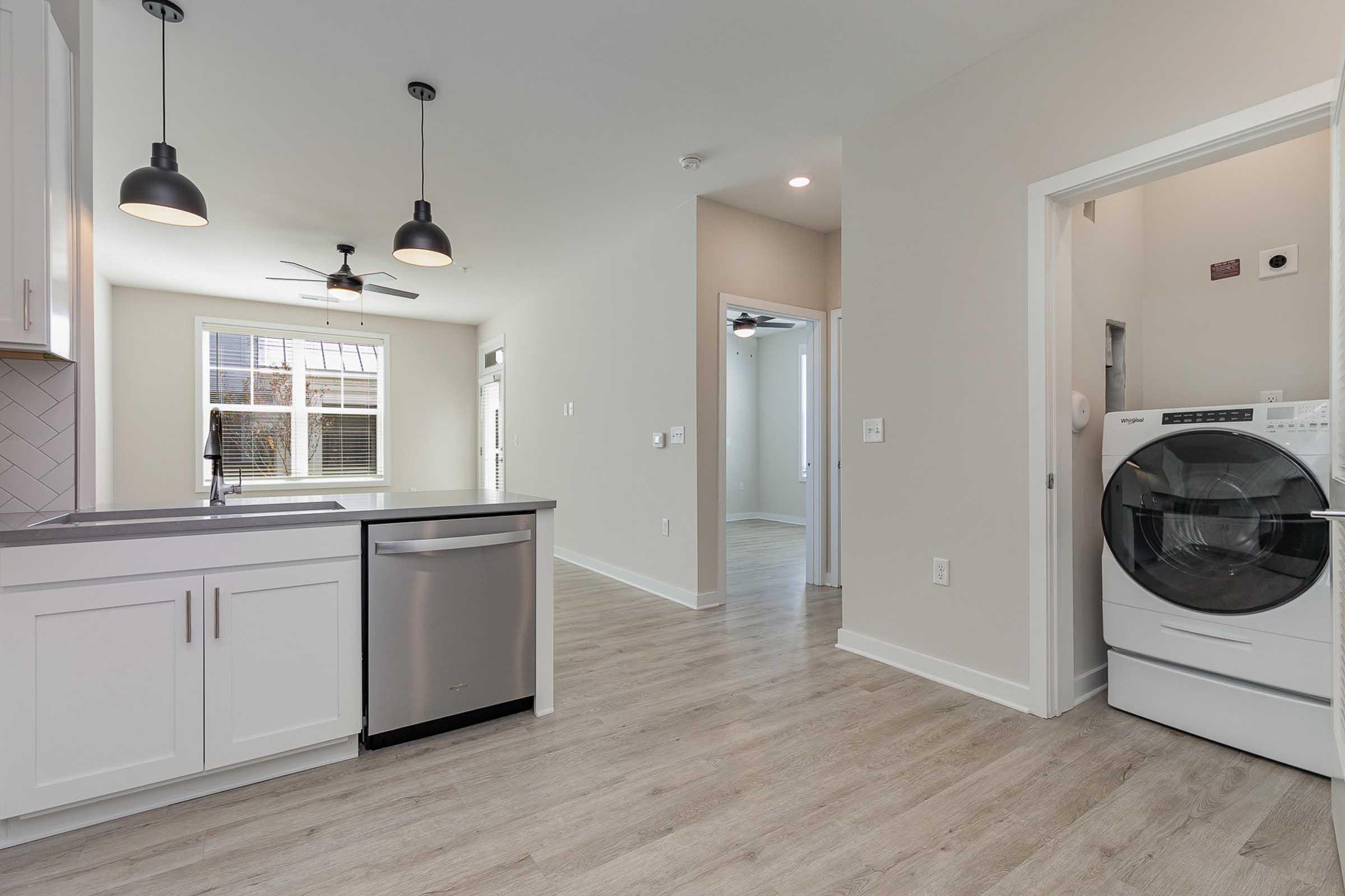 a kitchen with a sink and a mirror in a room