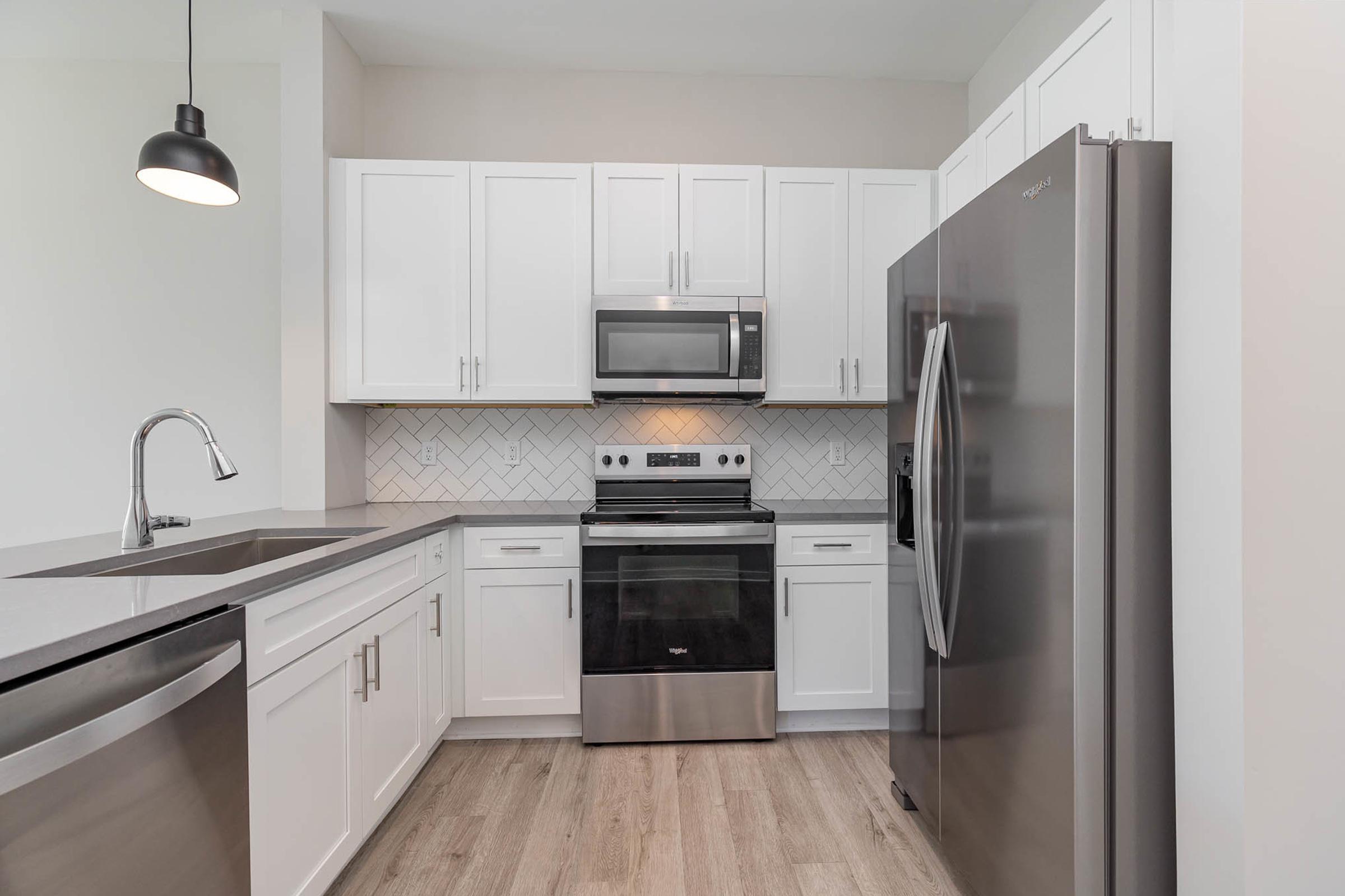 a kitchen with stainless steel appliances and wooden cabinets