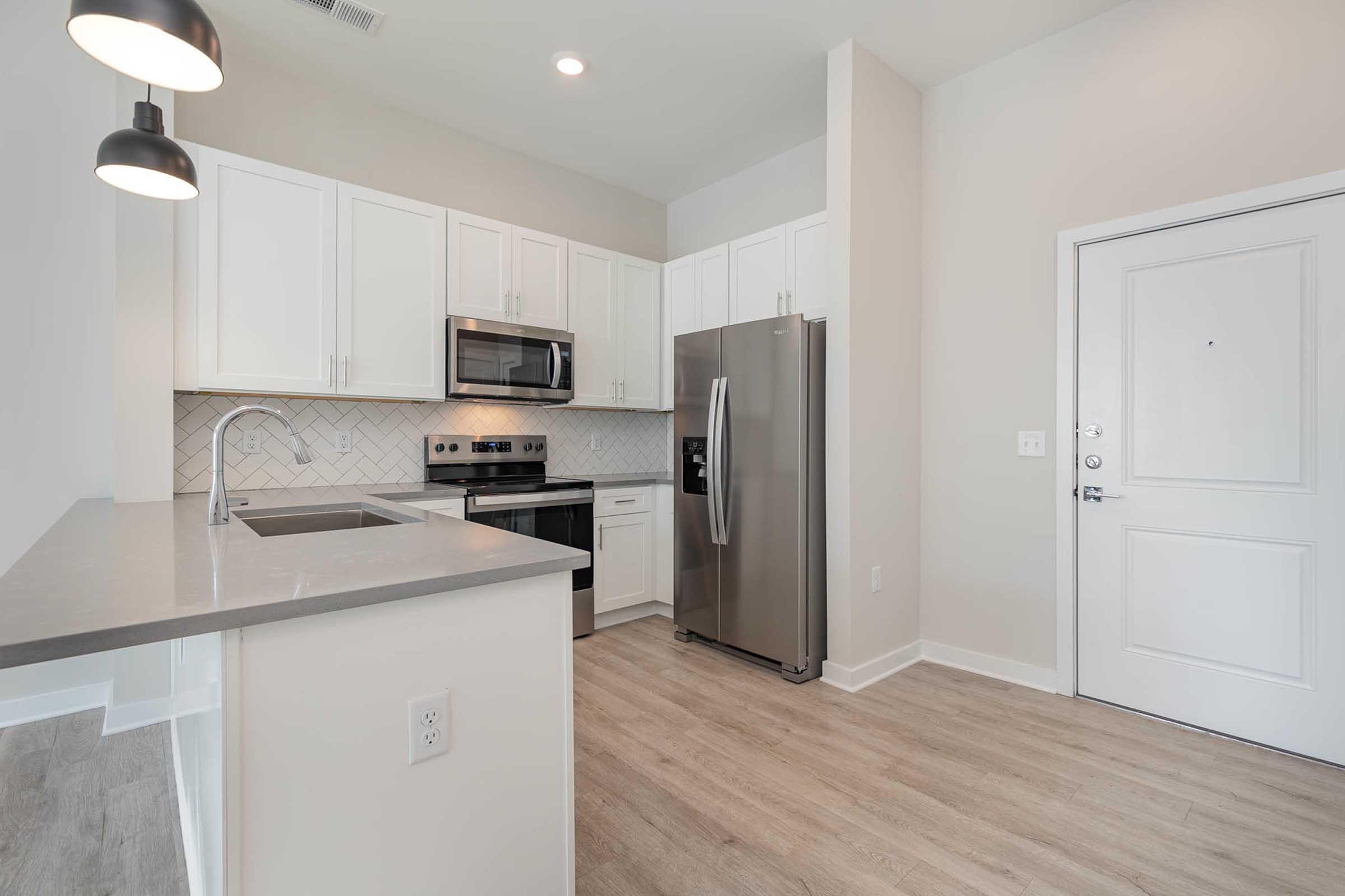 a kitchen with a sink and a refrigerator