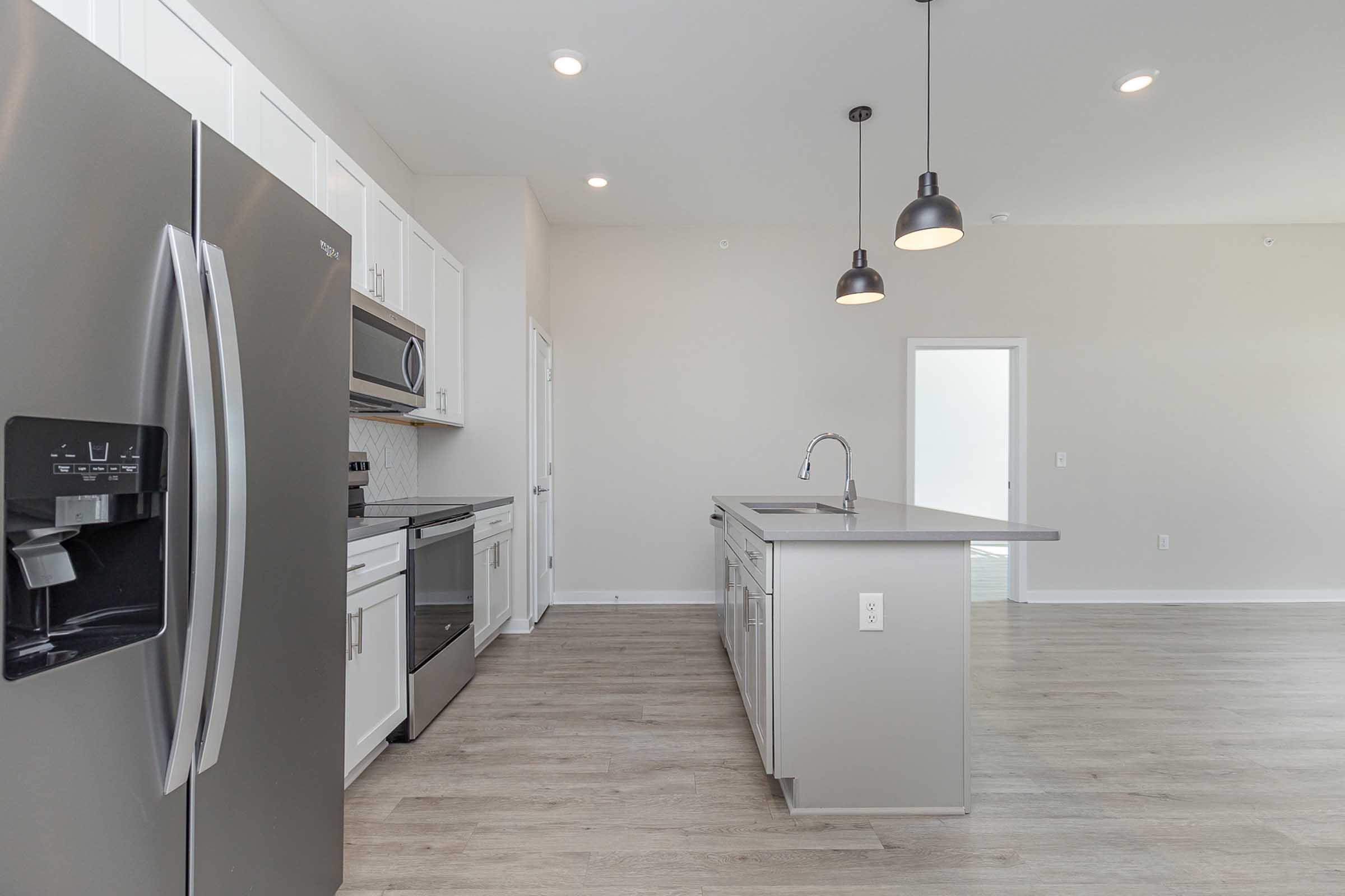 a kitchen with a sink and a refrigerator