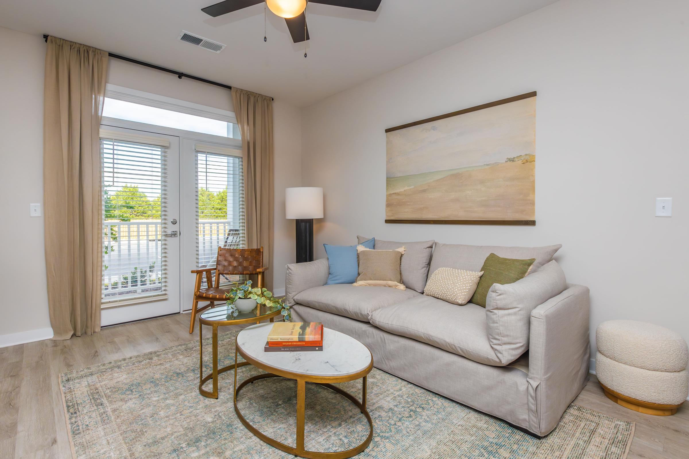 a living room filled with furniture and a large window