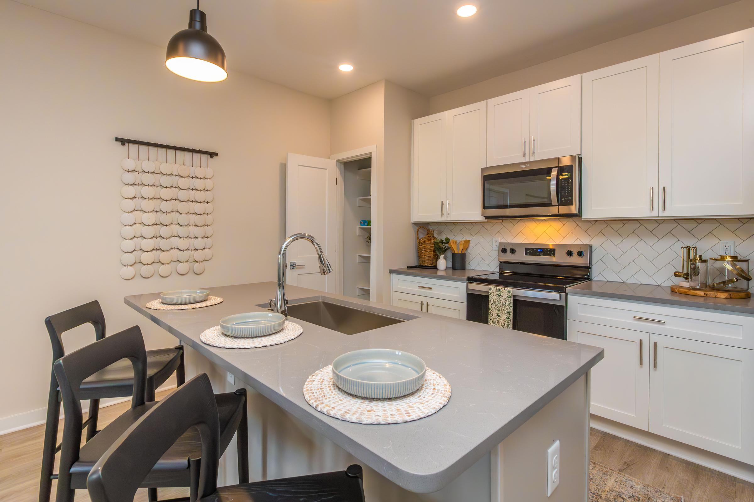 a kitchen with an island in the middle of a table