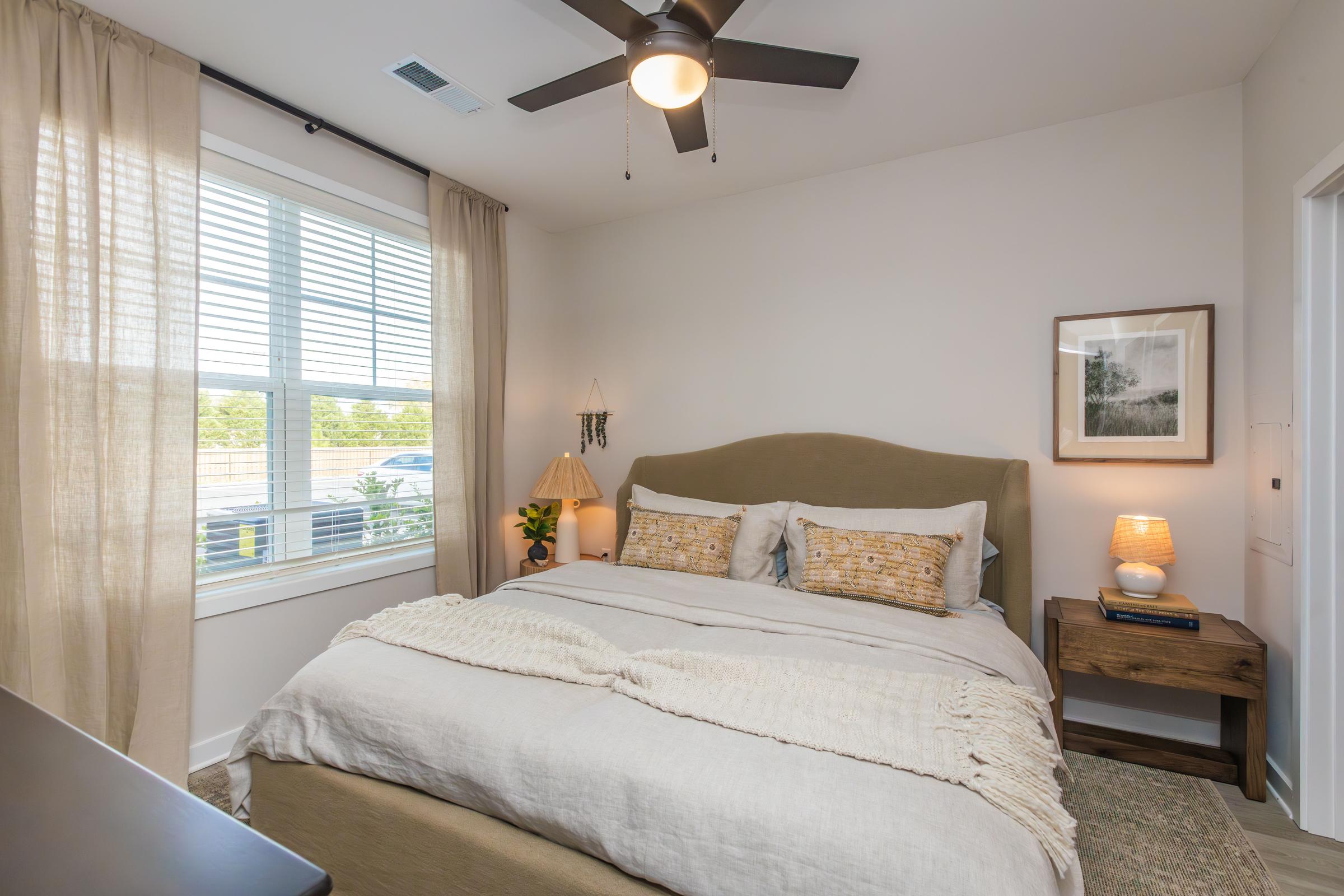 a bedroom with a bed and a window