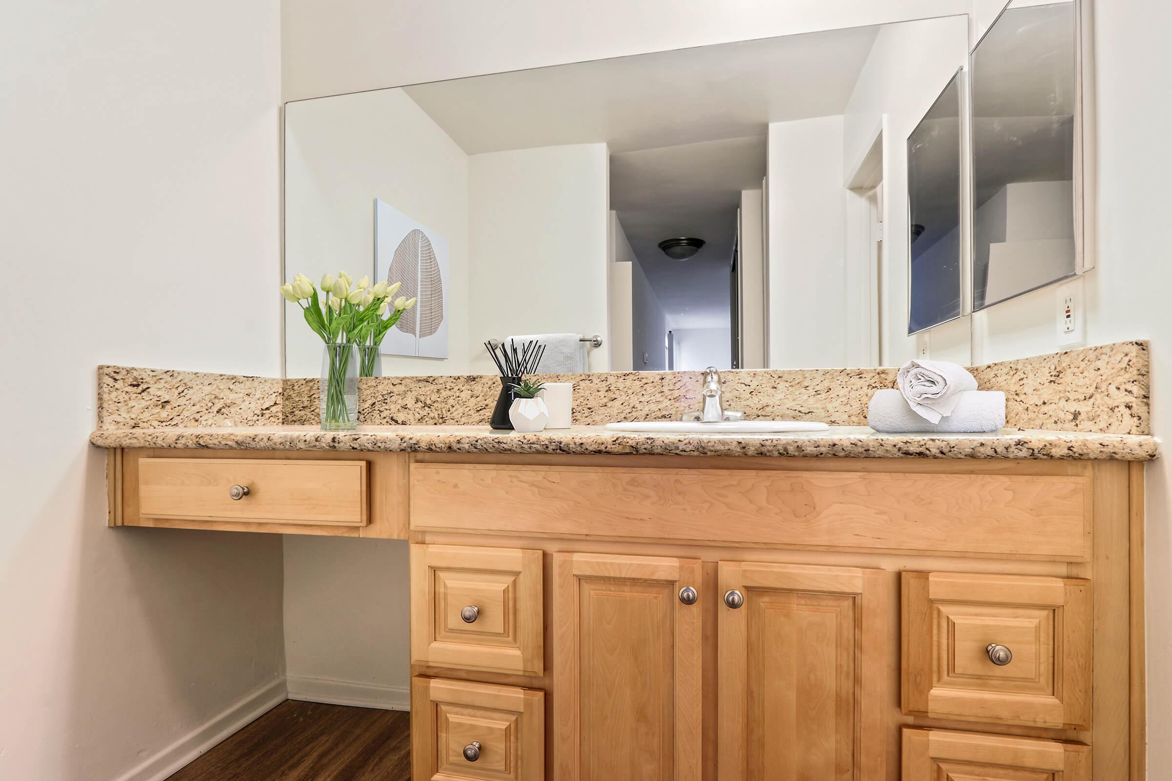 a kitchen with a sink and a mirror