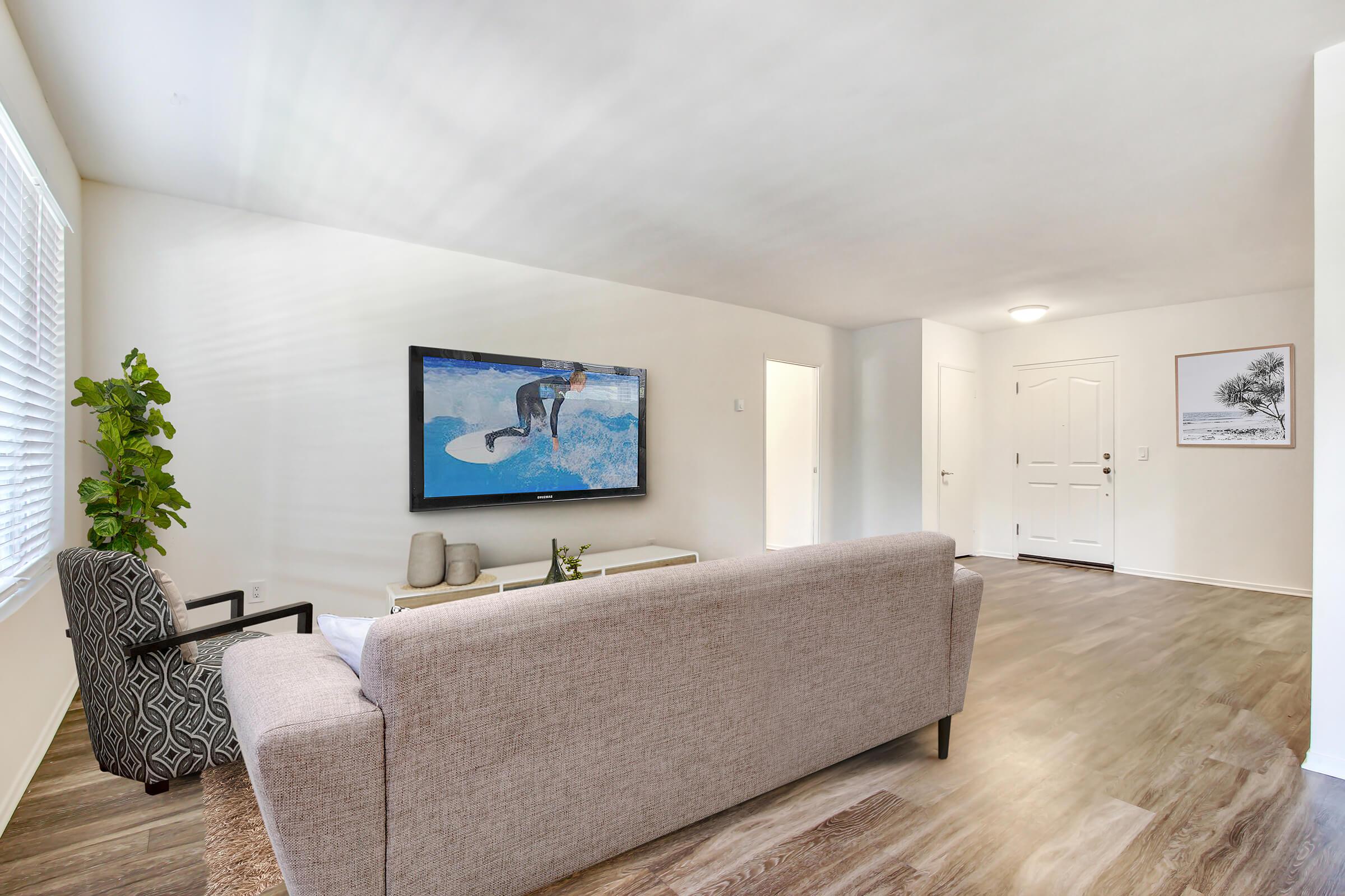 a living room filled with furniture and a large window