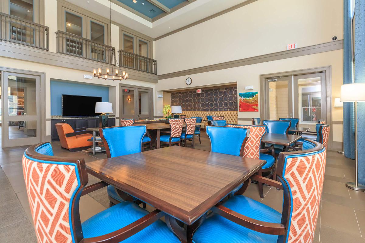 a living room filled with furniture and a blue chair