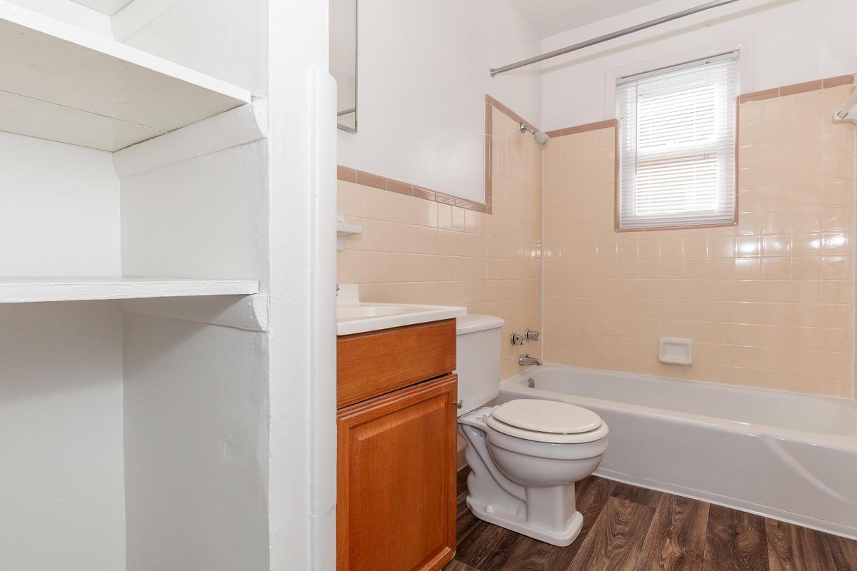 a white tub sitting next to a shower