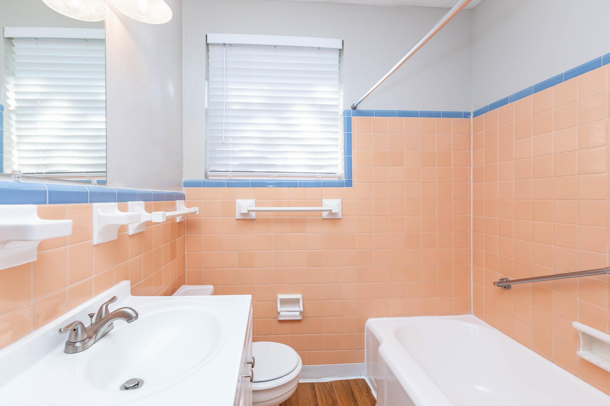 a white sink sitting next to a window