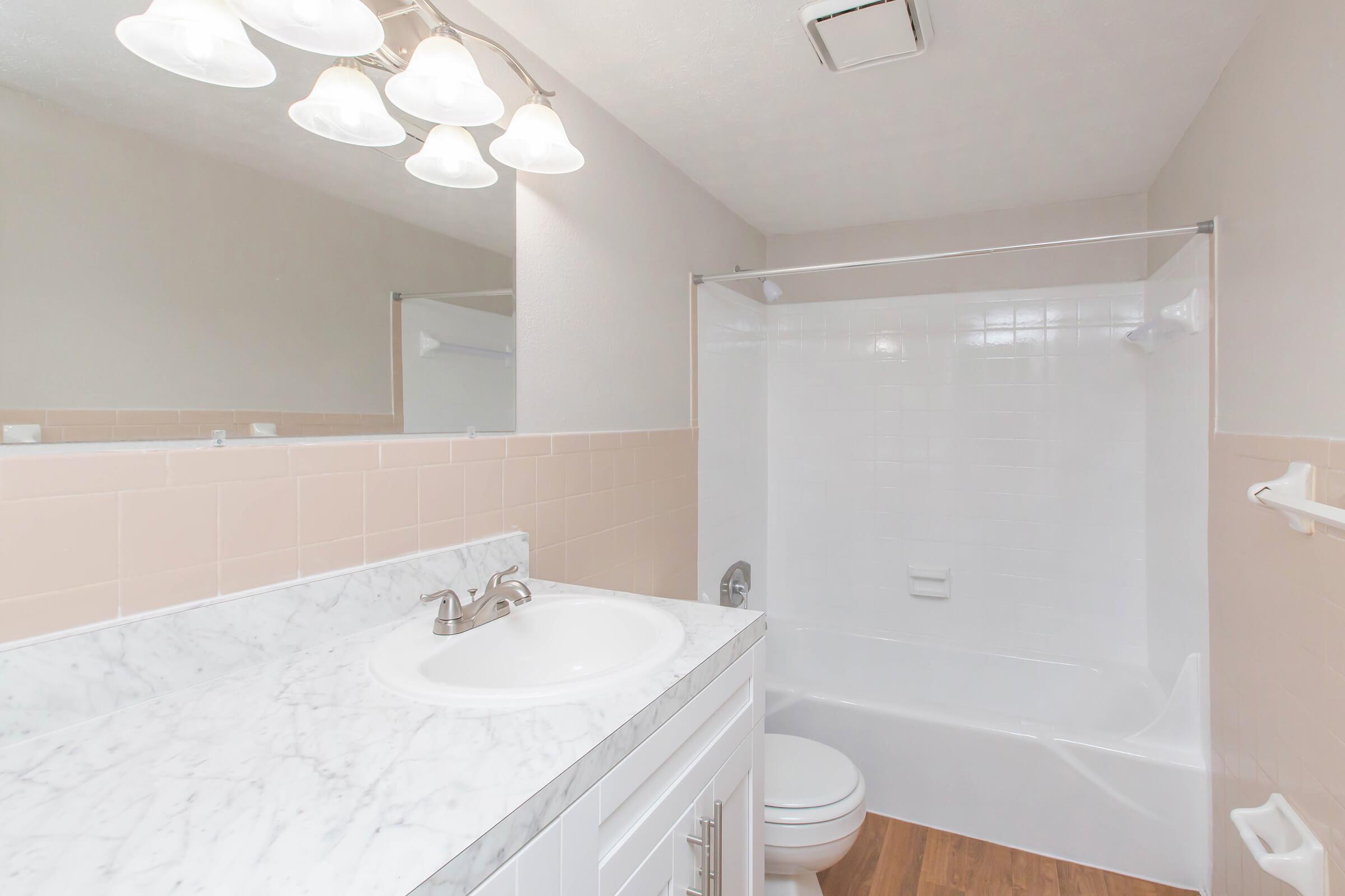 a large white tub next to a shower