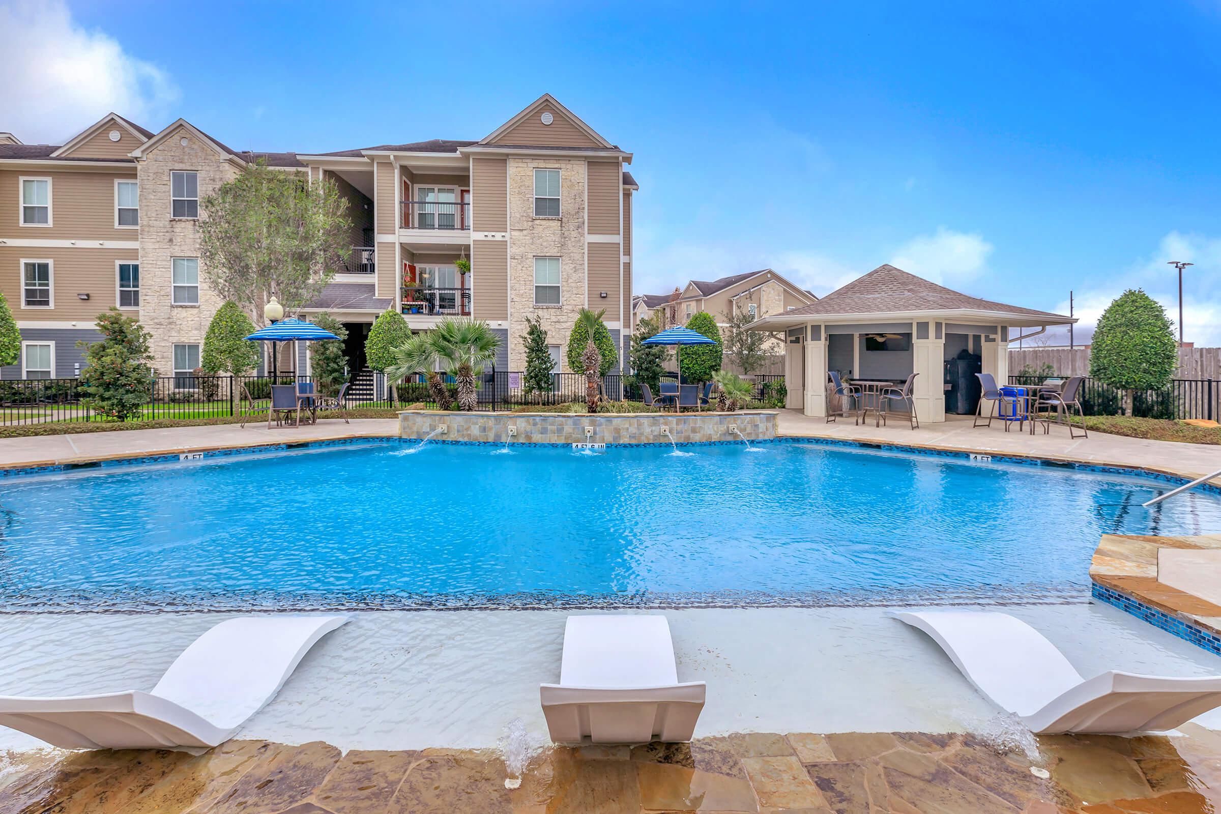 a large pool of water in front of a house