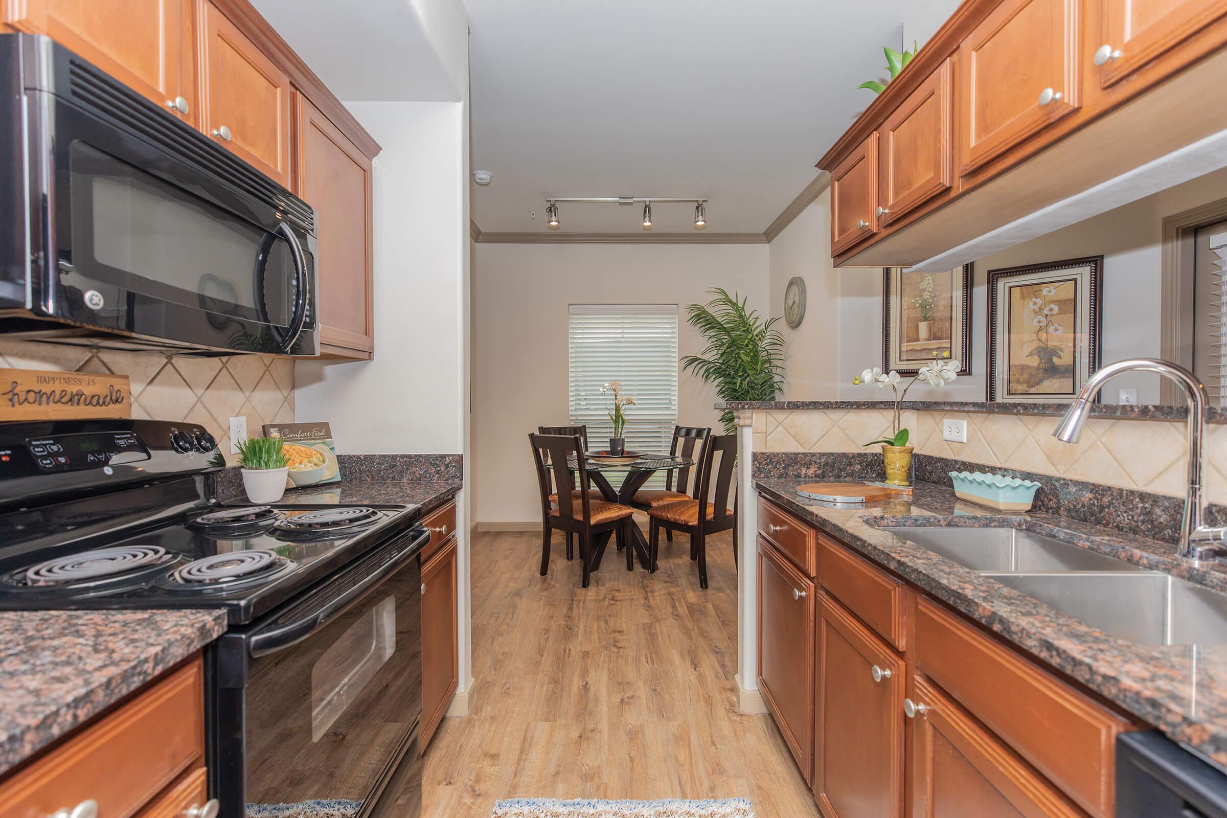 a modern kitchen with stainless steel appliances and wooden cabinets