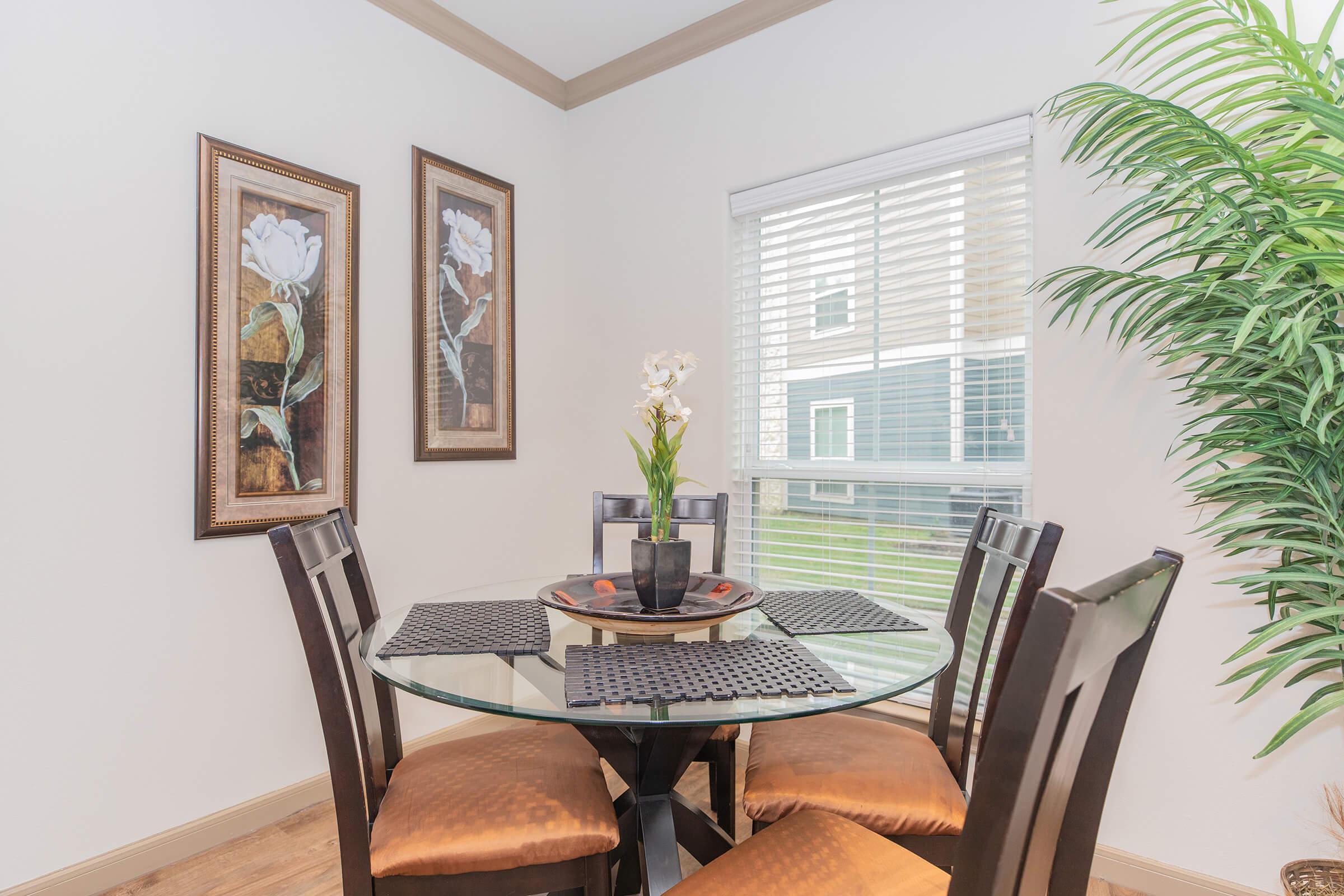 a dining room table in front of a window