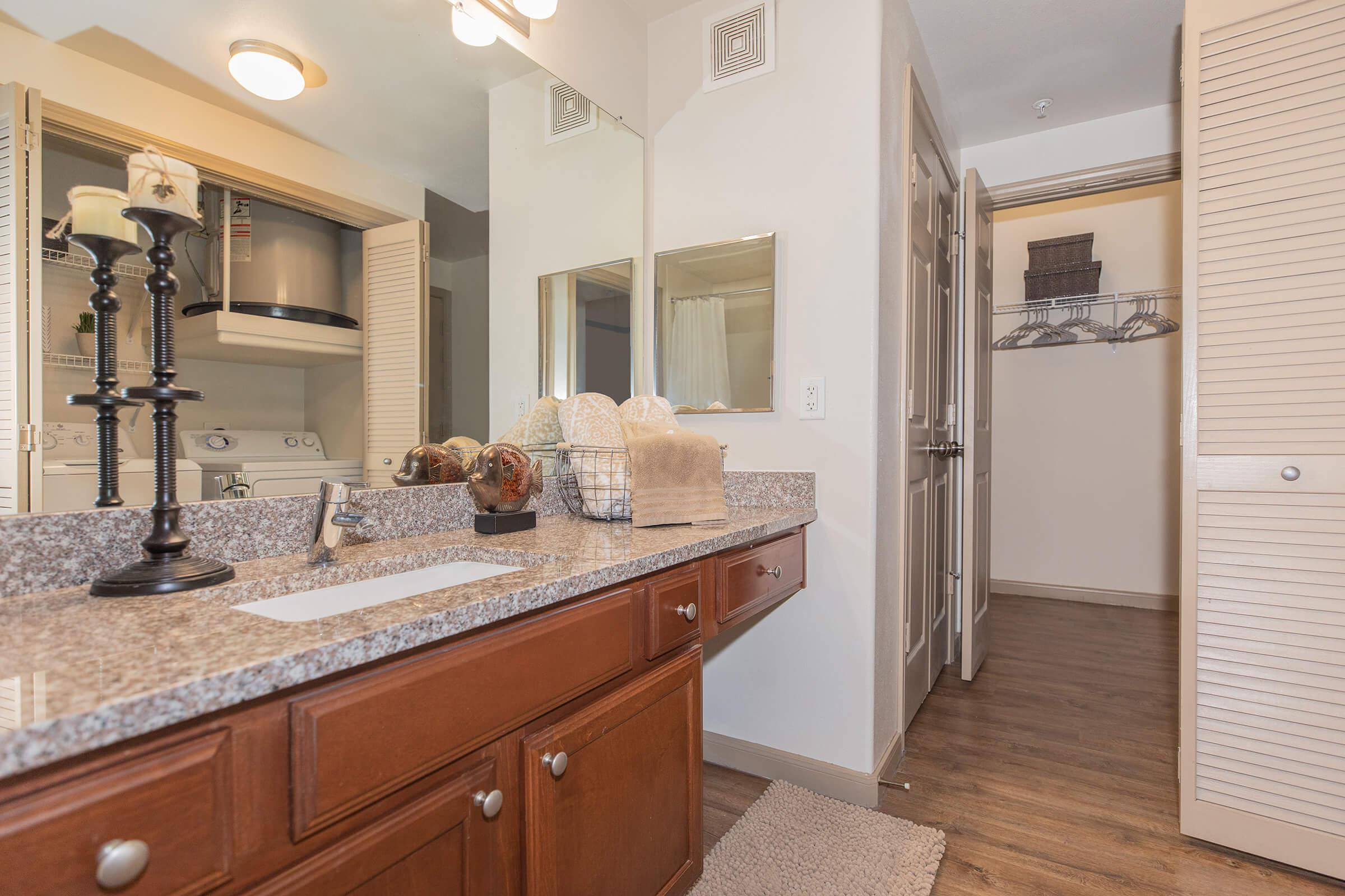 a kitchen with a sink and a mirror