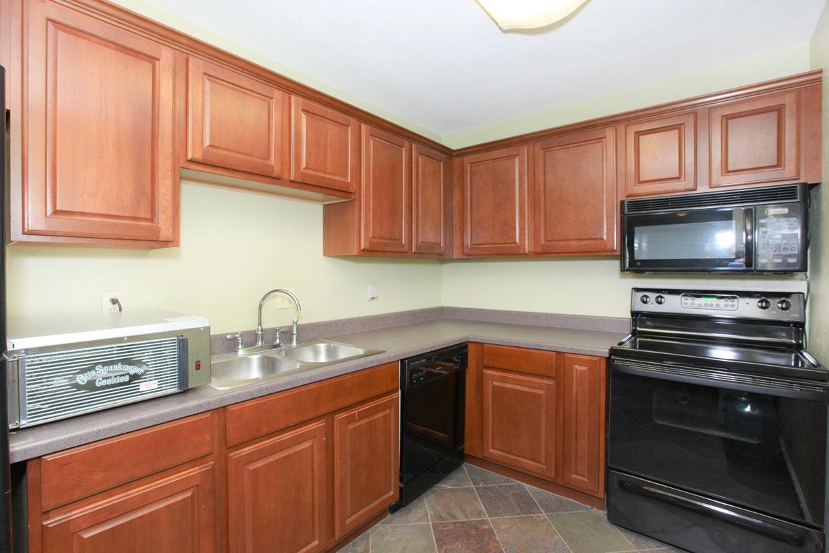 a kitchen with stainless steel appliances and wooden cabinets