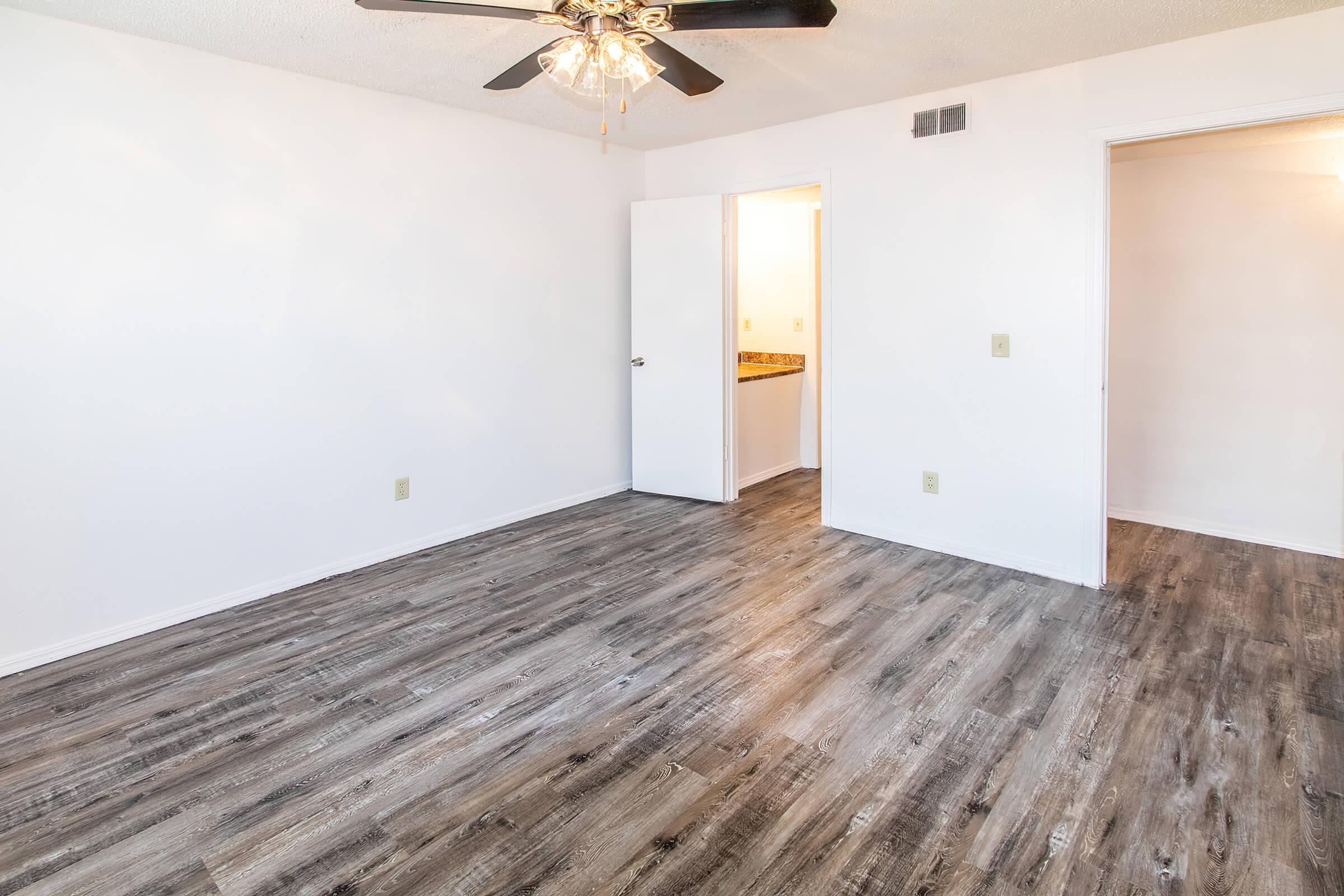 a bedroom with a wooden floor