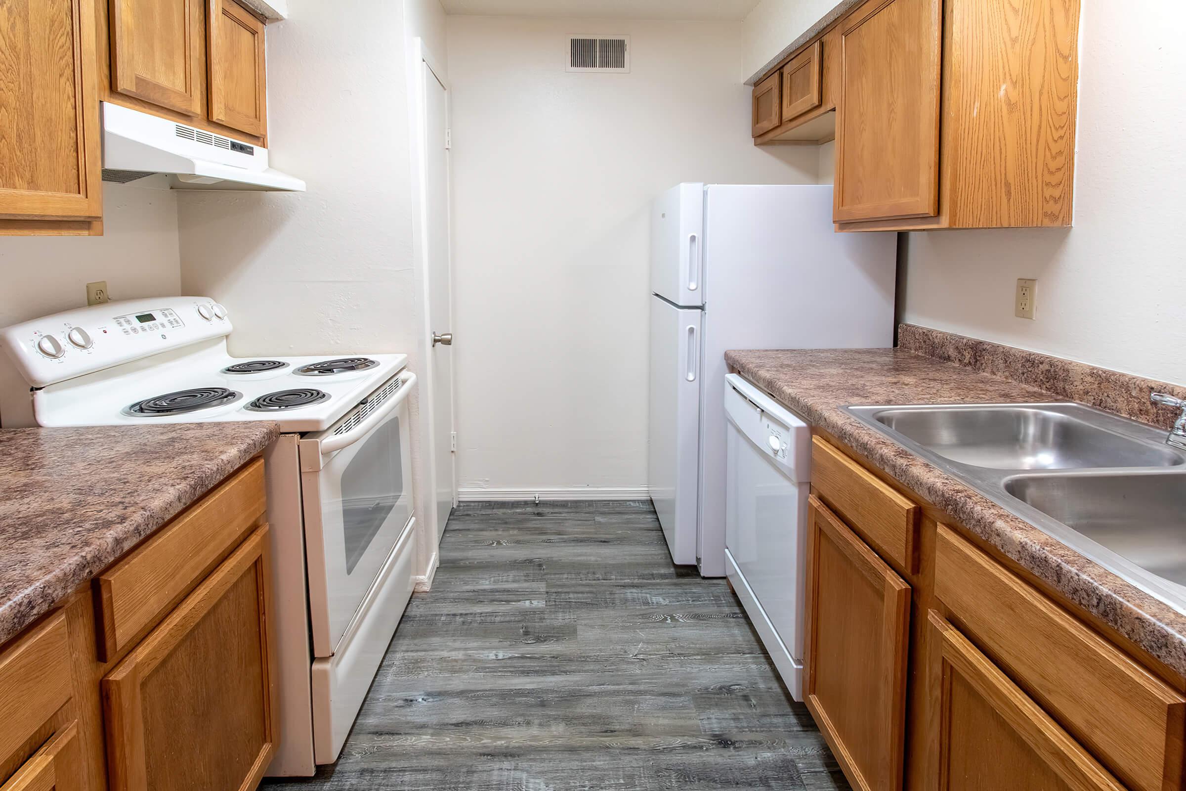 a kitchen with a stove sink and refrigerator