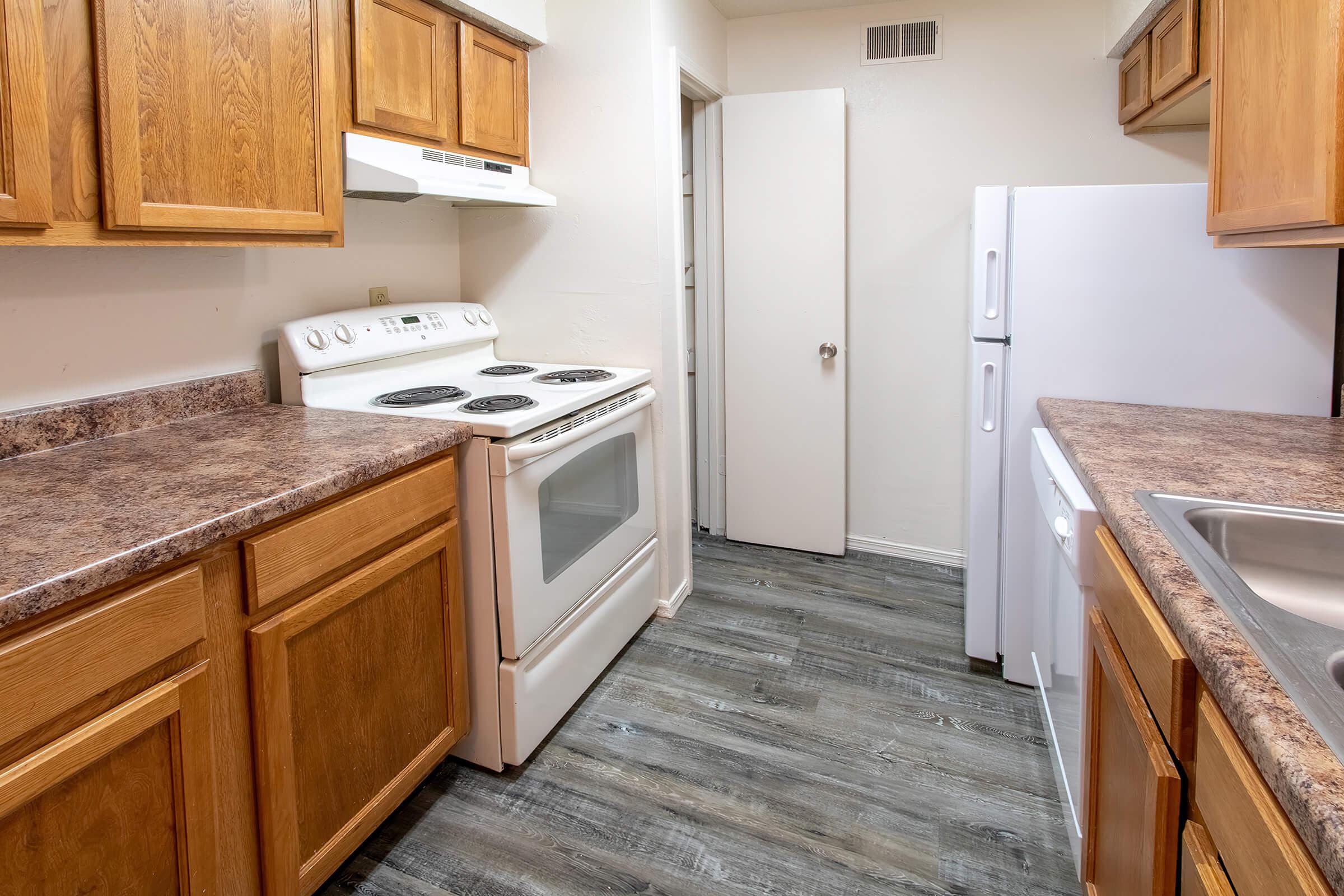 a stove top oven sitting inside of a kitchen