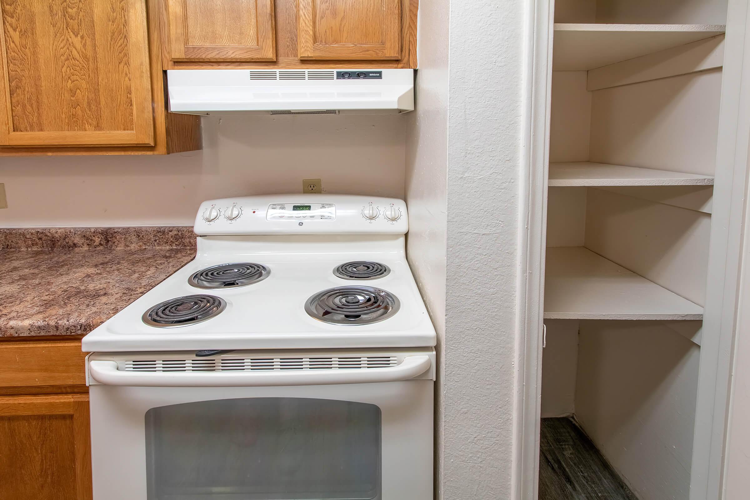 a stove top oven sitting inside of a kitchen