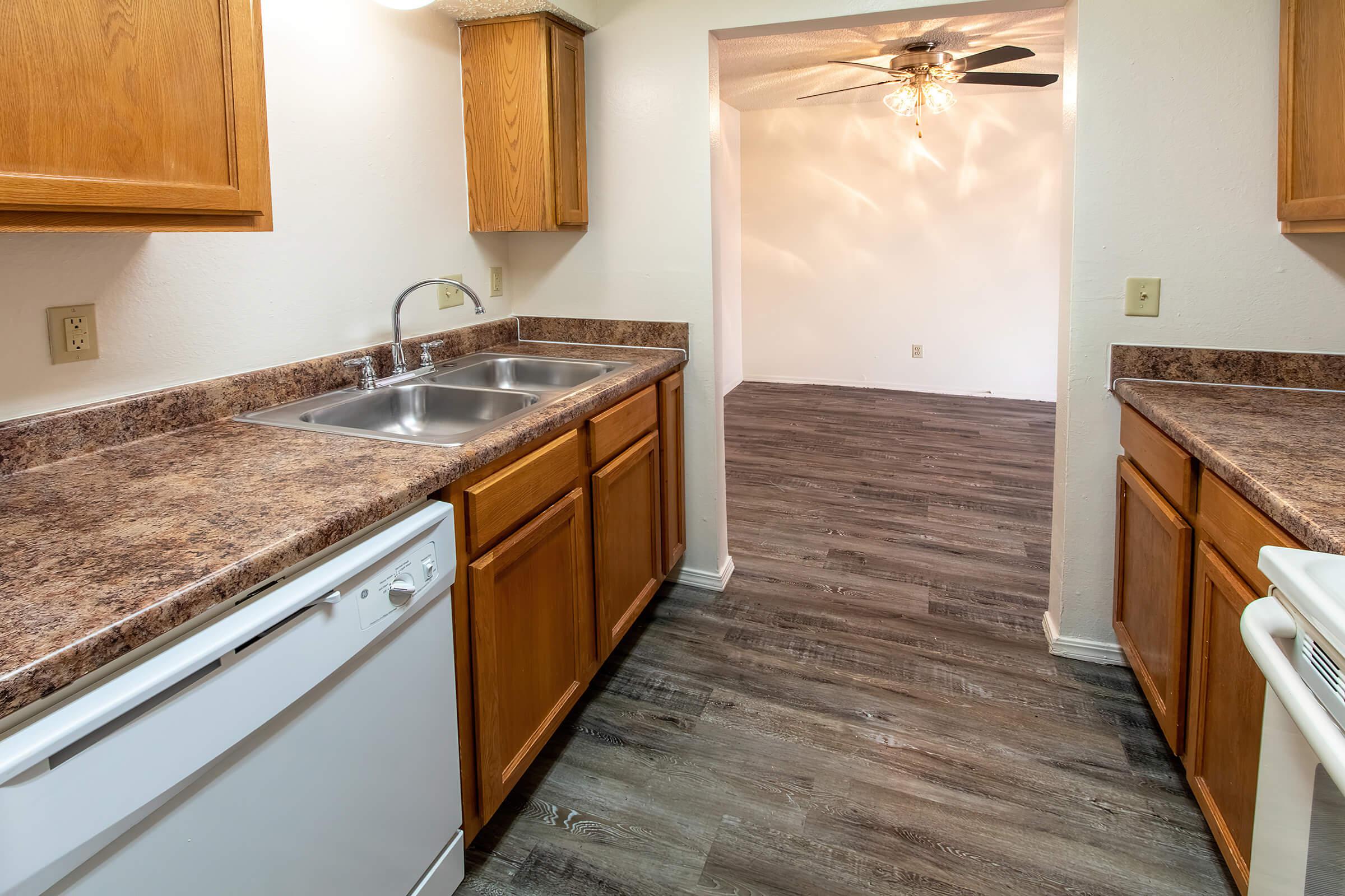 a kitchen with wooden cabinets and a sink