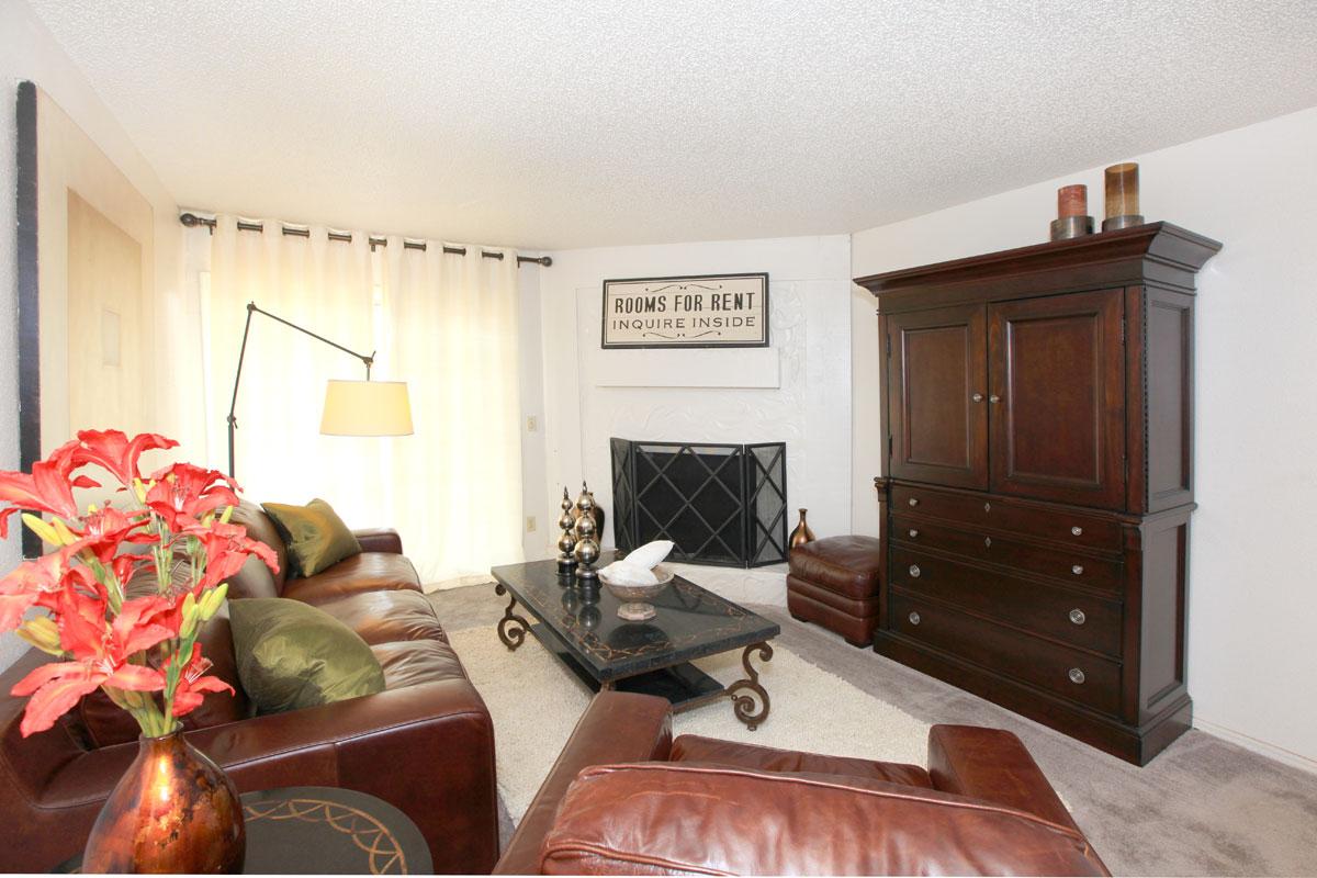 a living room filled with furniture and a flat screen tv