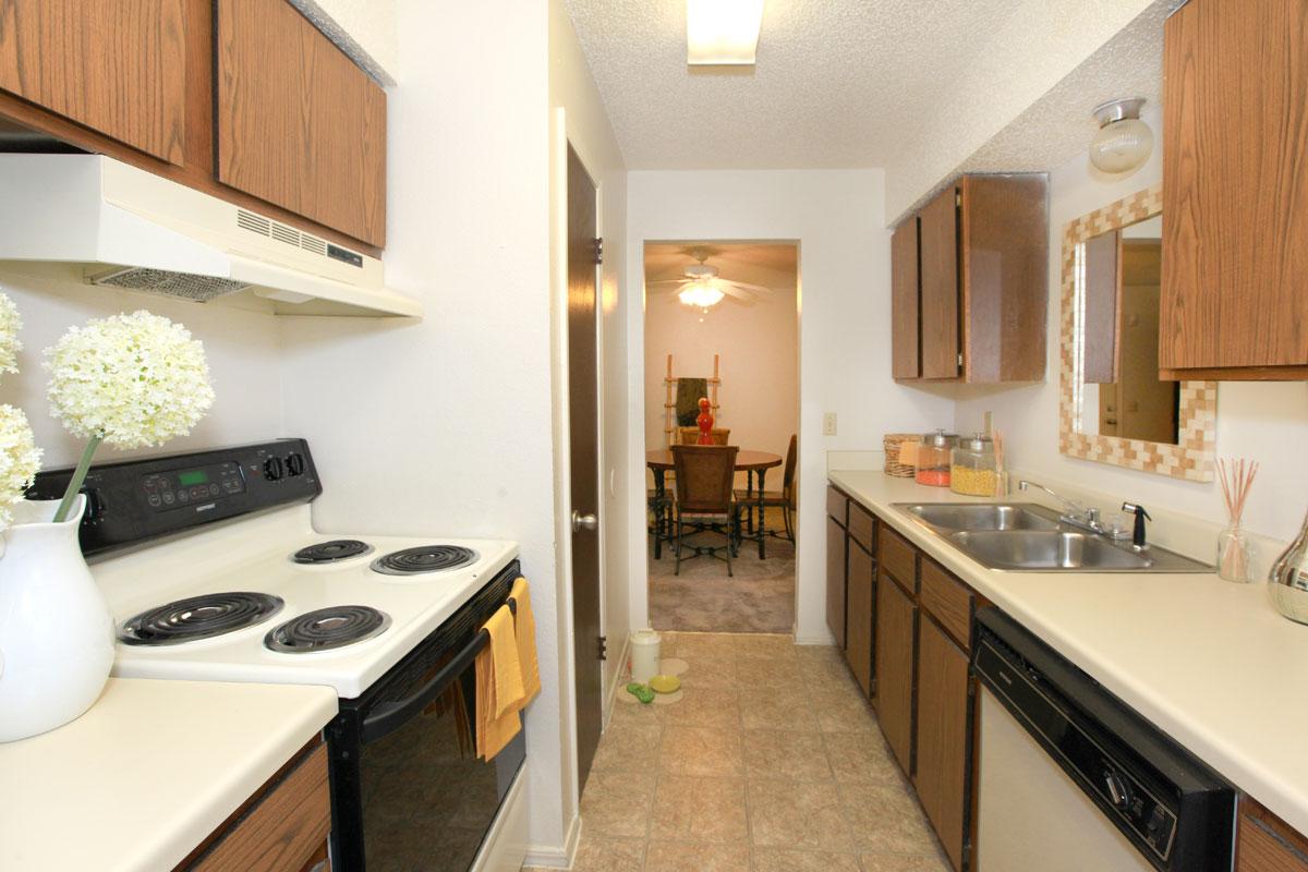 a white stove top oven sitting inside of a kitchen