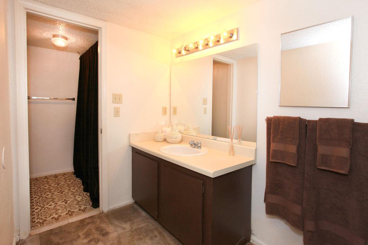 a hotel room with a sink and a mirror