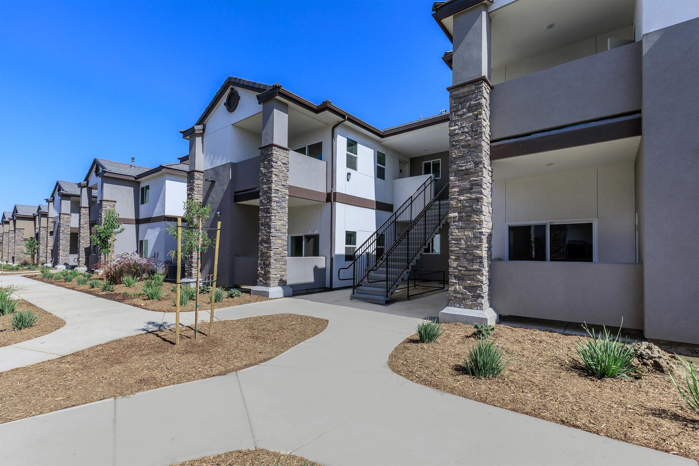 The Boardwalk Luxury Apartments community buildings with green trees