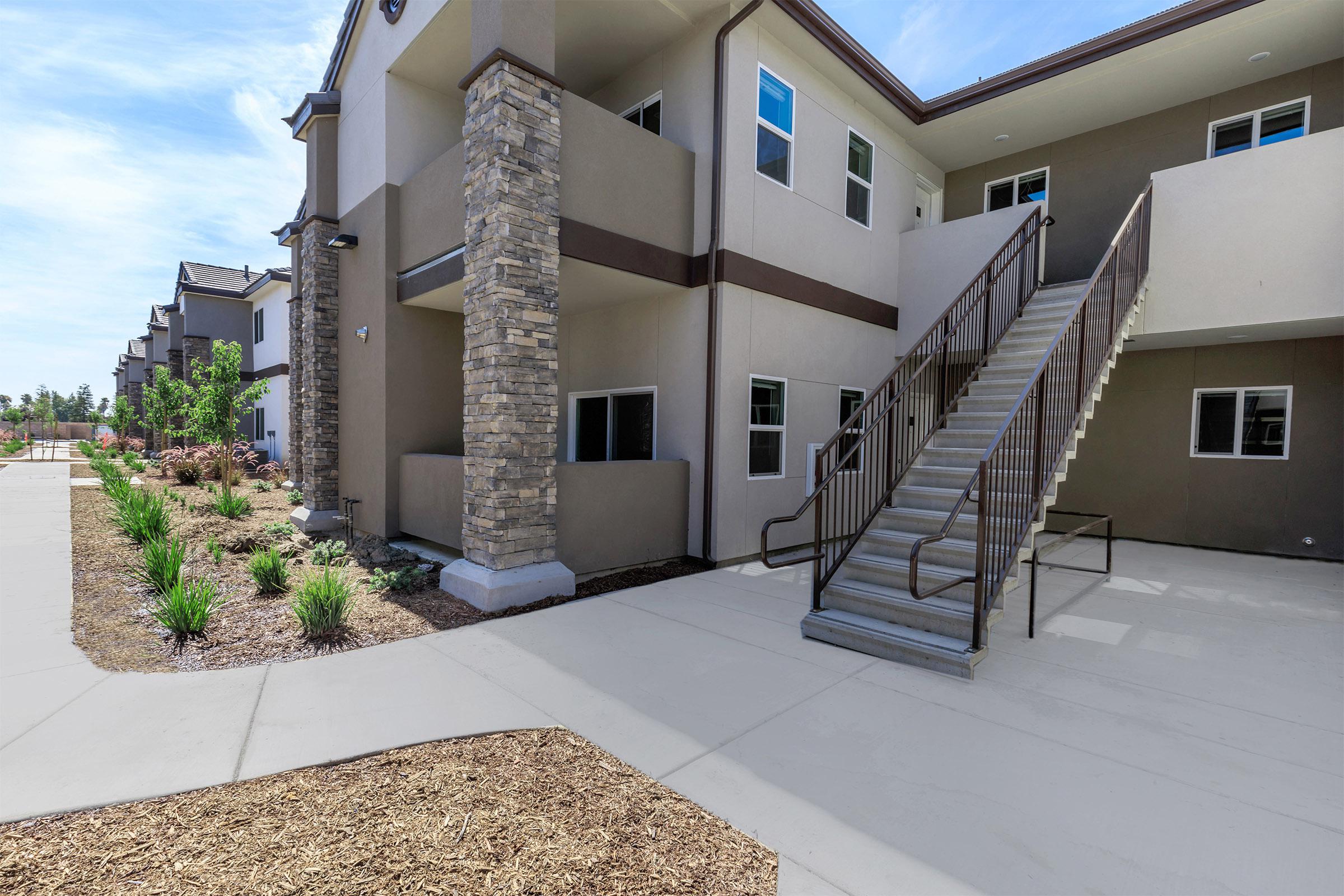 The Boardwalk Luxury Apartments community building with stairs