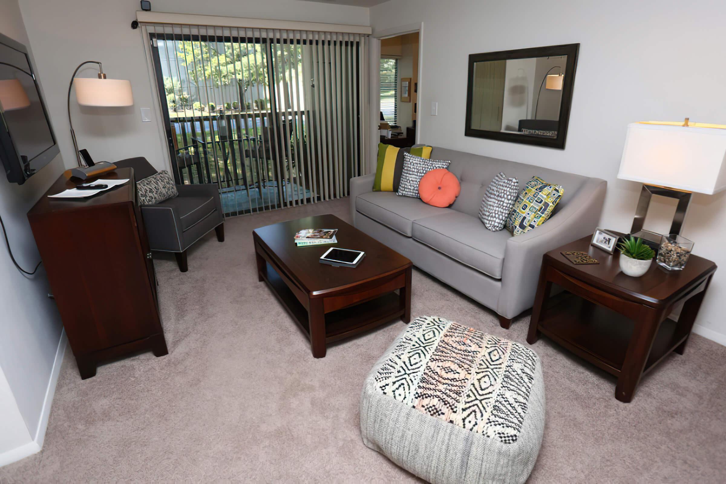 a living room filled with furniture and a tv