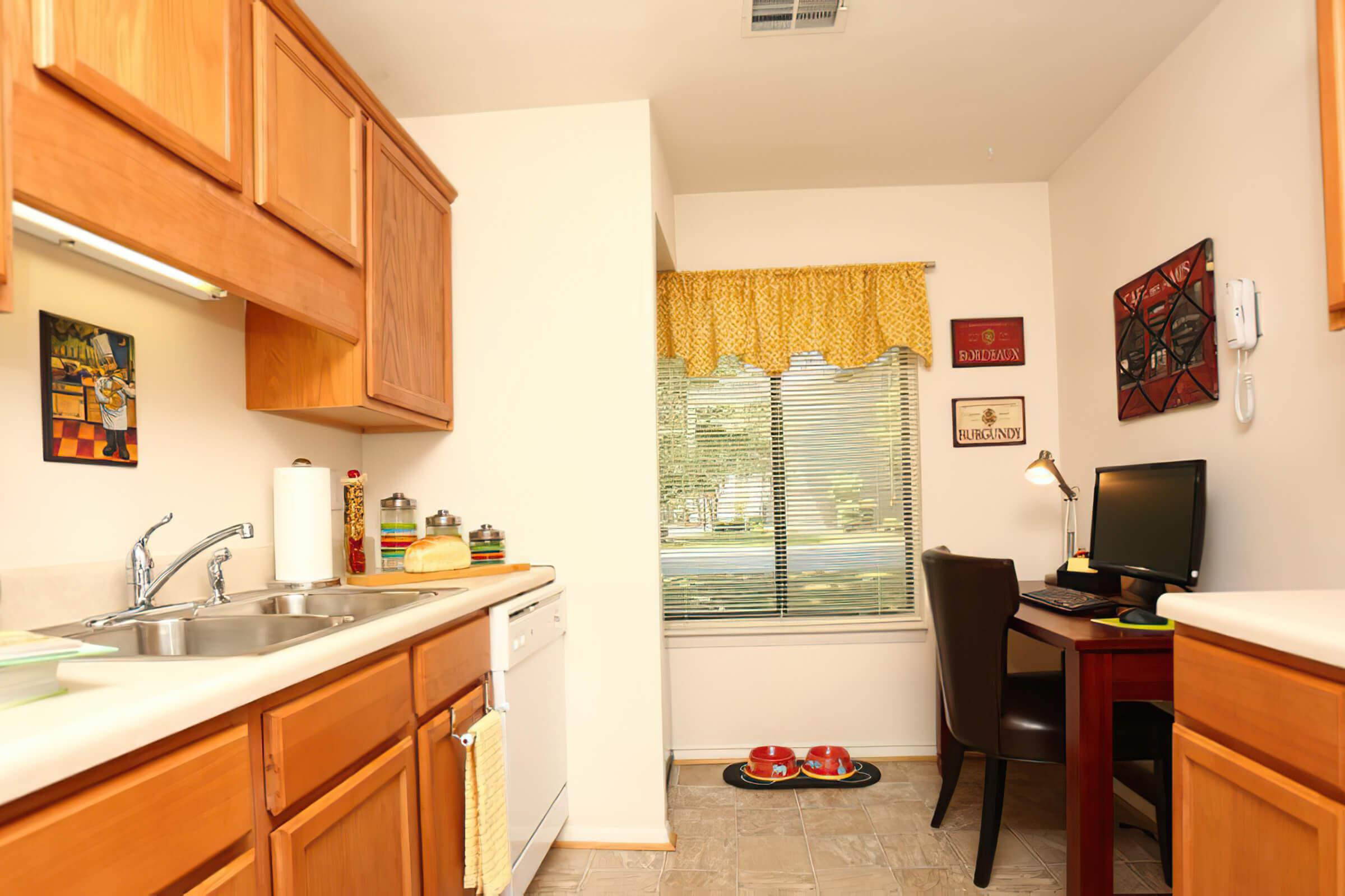 a kitchen with a sink and a mirror