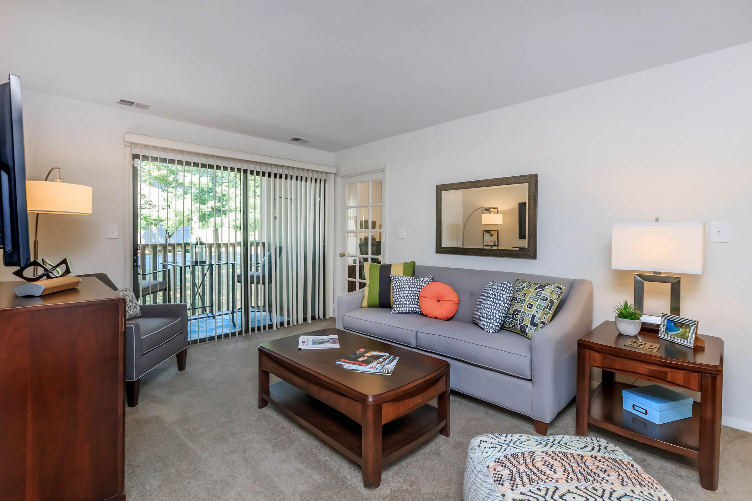 a living room filled with furniture and a flat screen tv