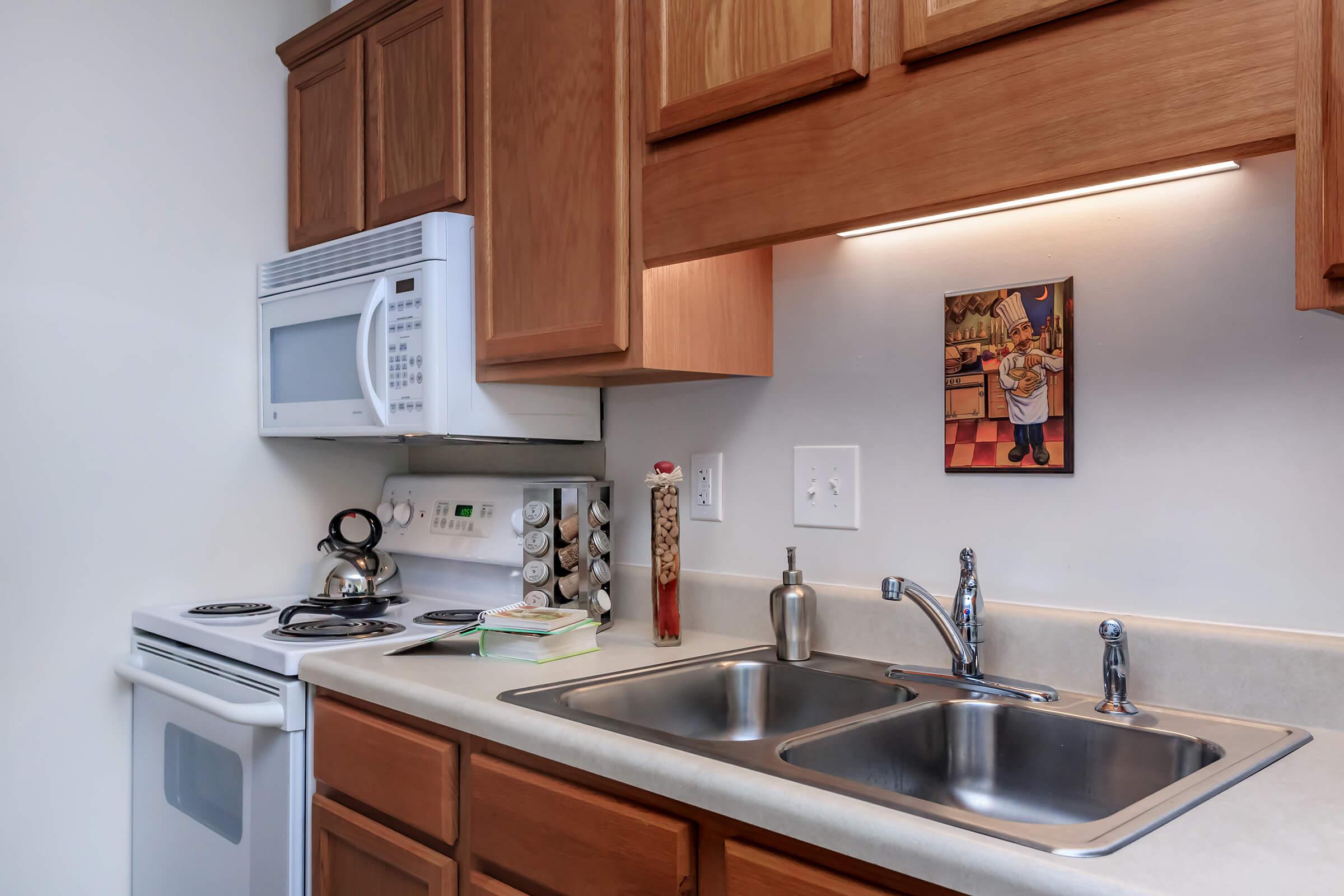 a kitchen with a stove a sink and a microwave